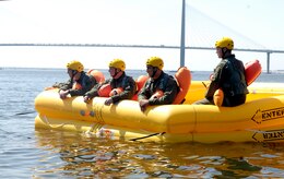 Aircrew from Joint Base Charleston float in a 46-man raft in the Charleston Harbor in Charleston, S.C., April 5, 2010. As part of the water survival training they are required to complete, the Airmen have to jump into the water and swim to a one man raft and attempt board it without kicking their feet because continuous movement and splashing attracts unwanted attention from potentially dangerous predators. Airmen also have to swim beneath a parachute ring and find their way out on the other side. The exercise is used to simulate survival skills after parachuting into a body of water. (U.S. Air Force Photo/Airman 1st Class Lauren Main)