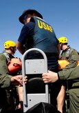 U.S. Air Force Master Sgt. Gregory Turner steers a small boat filled with aircrew members toward a training site for a water survival class in the Charleston Harbor in Charleston, S.C., April 5, 2010. All pilots and aircrew must receive a portion of their initial Survival, Evasion, Resistance and Escape training in the event of an aircraft emergency. Sergeant Turner is a SERE specialist with the 437th Operations Support Squadron. (U.S. Air Force Photo/Airman 1st Class Lauren Main)