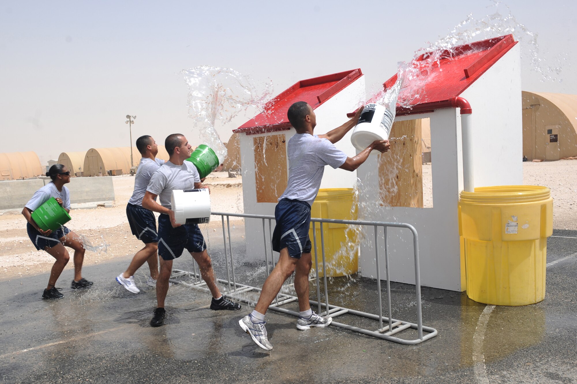 The 379th Expeditionary Logistics Readiness team competed against the 379th Expeditionary Force Support Squadron team in a water bucket competition during base firefighter games at a non-disclosed Southwest Asia location, Apr 10, 2010. (U.S. Air Force photo by Tech. Sgt. Michelle Larche)[RELEASED]