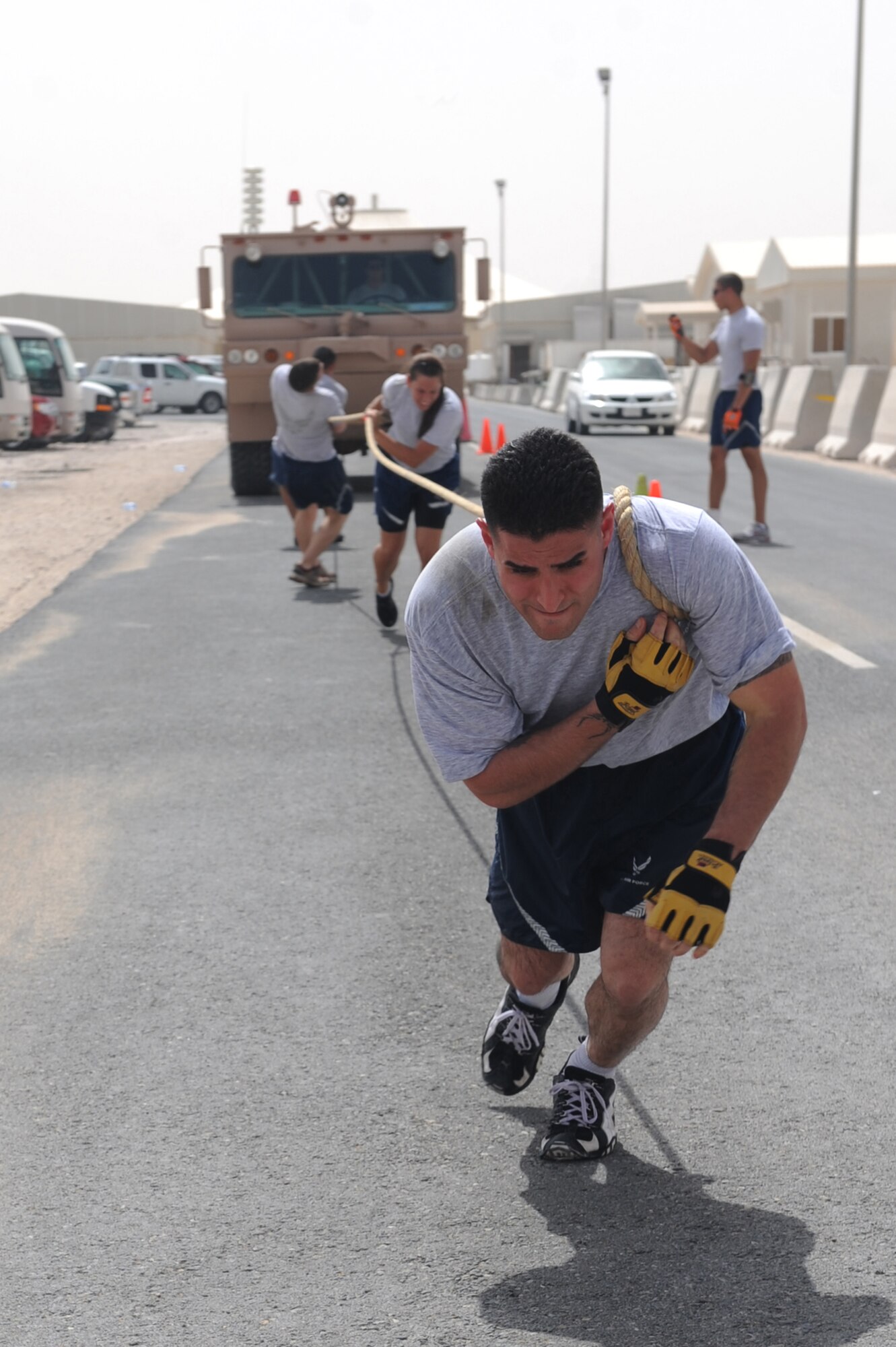 Staff Sgt. George Munoz (front) Airman 1st Class Elyse Lindsay, Senior Airman Joshua Olson and Airman 1st Class Erik Chavarria, 379th Expeditionary Maintenance Squadron, pull a fire truck during base firefighter games at a non-disclosed Southwest Asia location, Apr 10, 2010. (U.S. Air Force photo by Tech. Sgt. Michelle Larche)[RELEASED]