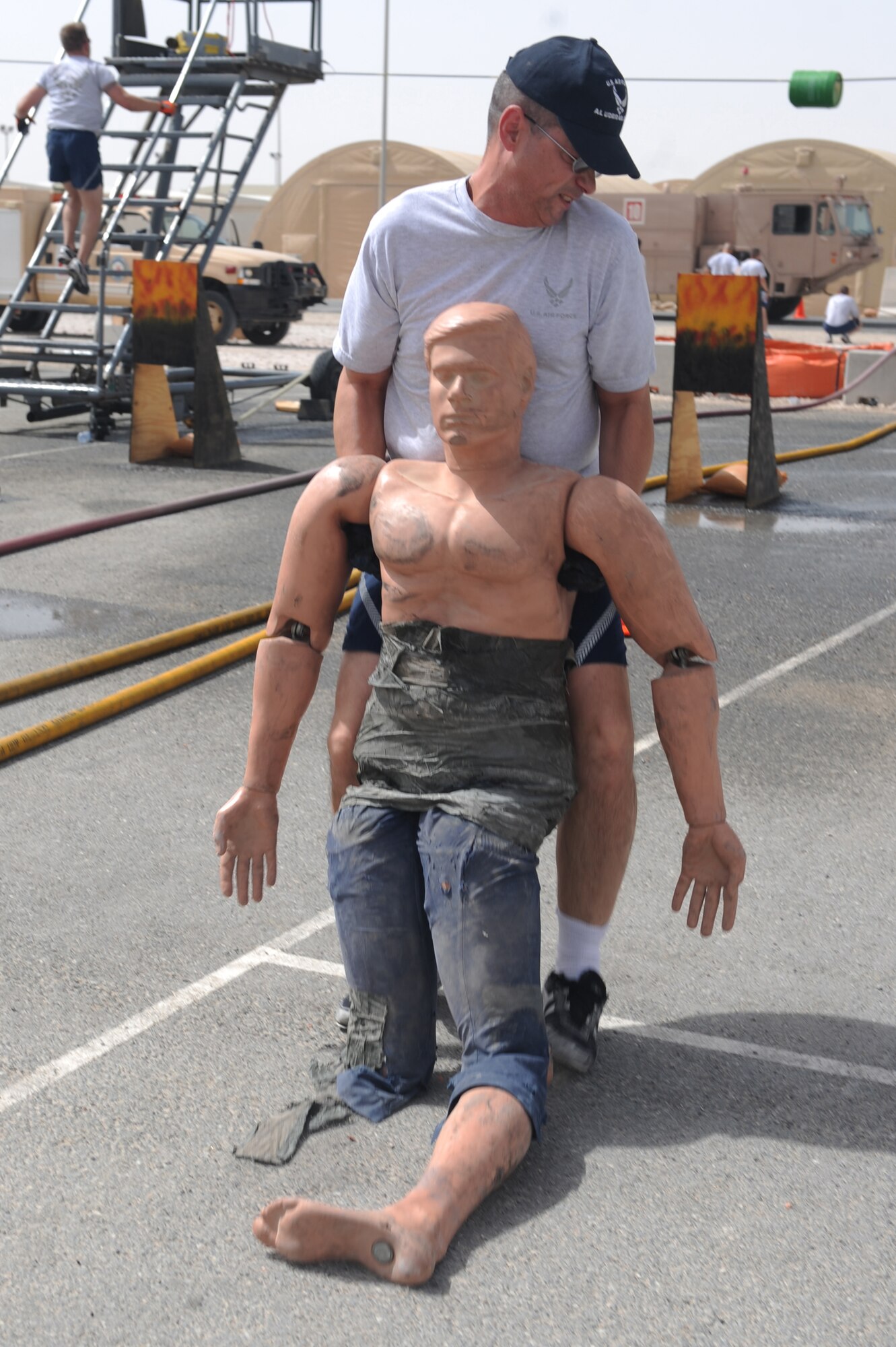 Tech Sgt. Frank Coulter, 379th Expeditionary Maintenance Squadron aircraft generation equipment technician, drags a dummy during the base firefighter games at a non-disclosed Southwest Asia location, Apr 10, 2010. (U.S. Air Force photo by Tech. Sgt. Michelle Larche)[RELEASED]