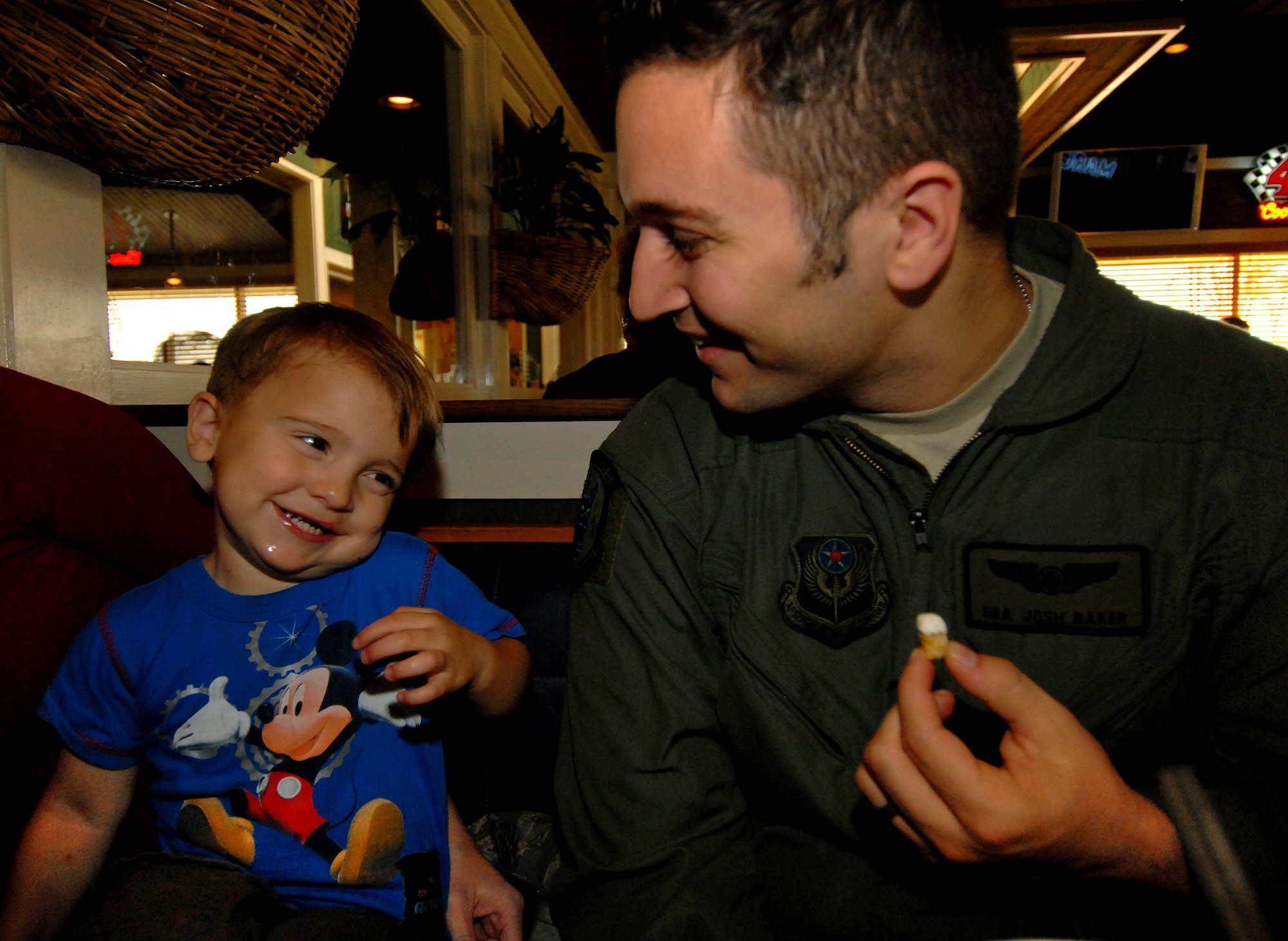 Jimmy Baker smiles at his dad, Senior Airman Josh Baker, a flight engineer with the 353rd Special Operations Group, while having lunch at Kadena Air Base, Japan, April 9. Jimmy, now 2 years old, was born with a cleft palate and lip. The Air Force Aid Society provided a $3,500 medical grant so that the Baker family could be together in Hawaii for Jimmy's surgery in 2008. (U.S. Air Force photo / Staff Sgt. Jason Lake)