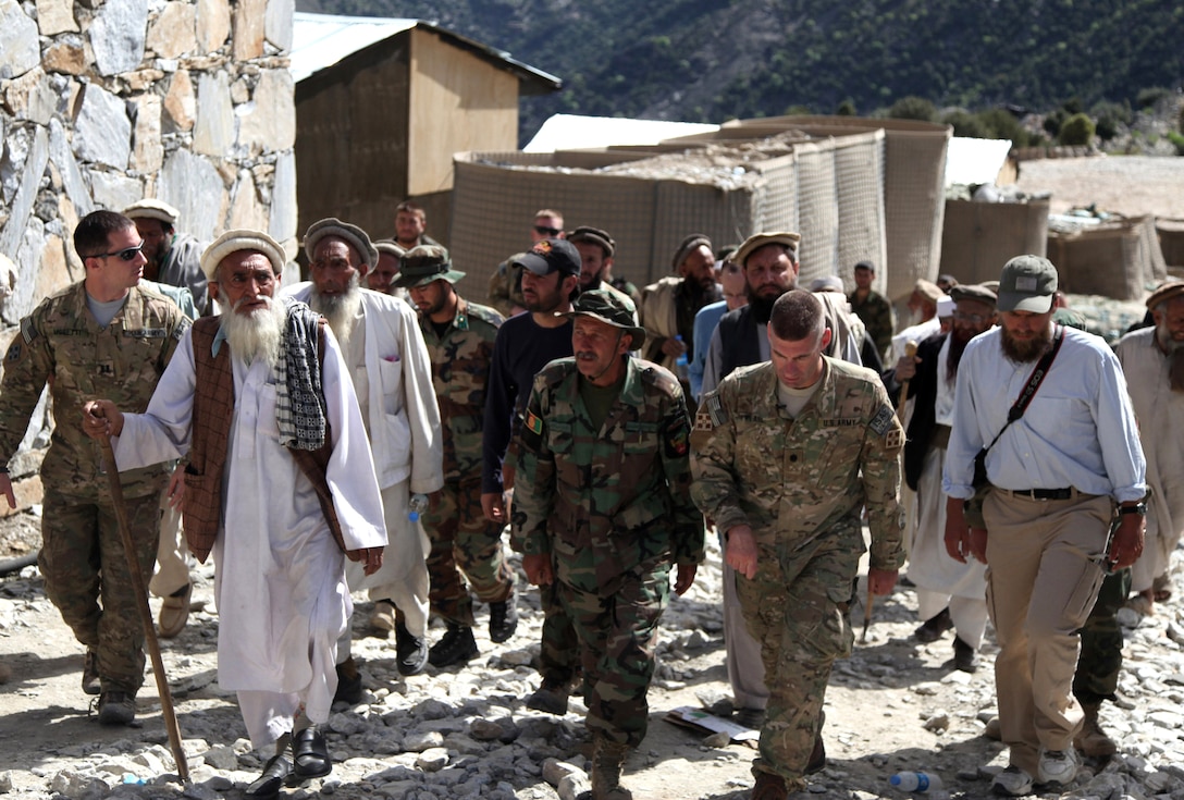 U.S. Army Lt. Col. Brian Pearl, Afghan National Army Lt. Col. Kohistani and senior Korengal valley elders walk with international troops through the Korengal Outpost in Afghanistan's Kunar province, April 13, 2010. Pearl showed the elders the structures and equipment that would be left behind at the outpost as international and Afghan forces move out of the valley into more populated areas. 