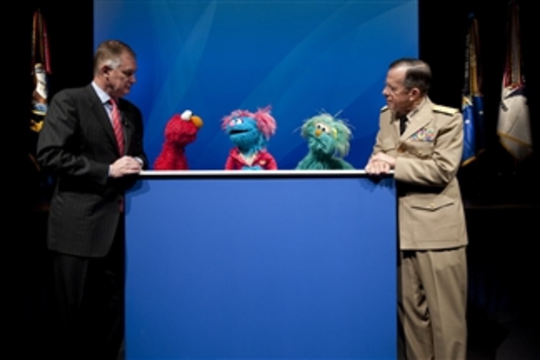 Deputy Secretary of Defense William J. Lynn, Chairman of the Joint Chiefs of Staff Adm. Mike Mullen and the Sesame Street Muppets Elmo, Jesse and Rosita host a preview of the PBS special "When Families Grieve" in the Pentagon on April 13, 2010.  The program portrays the tales of children coping with the loss of a parent and skills that have helped them move forward.  