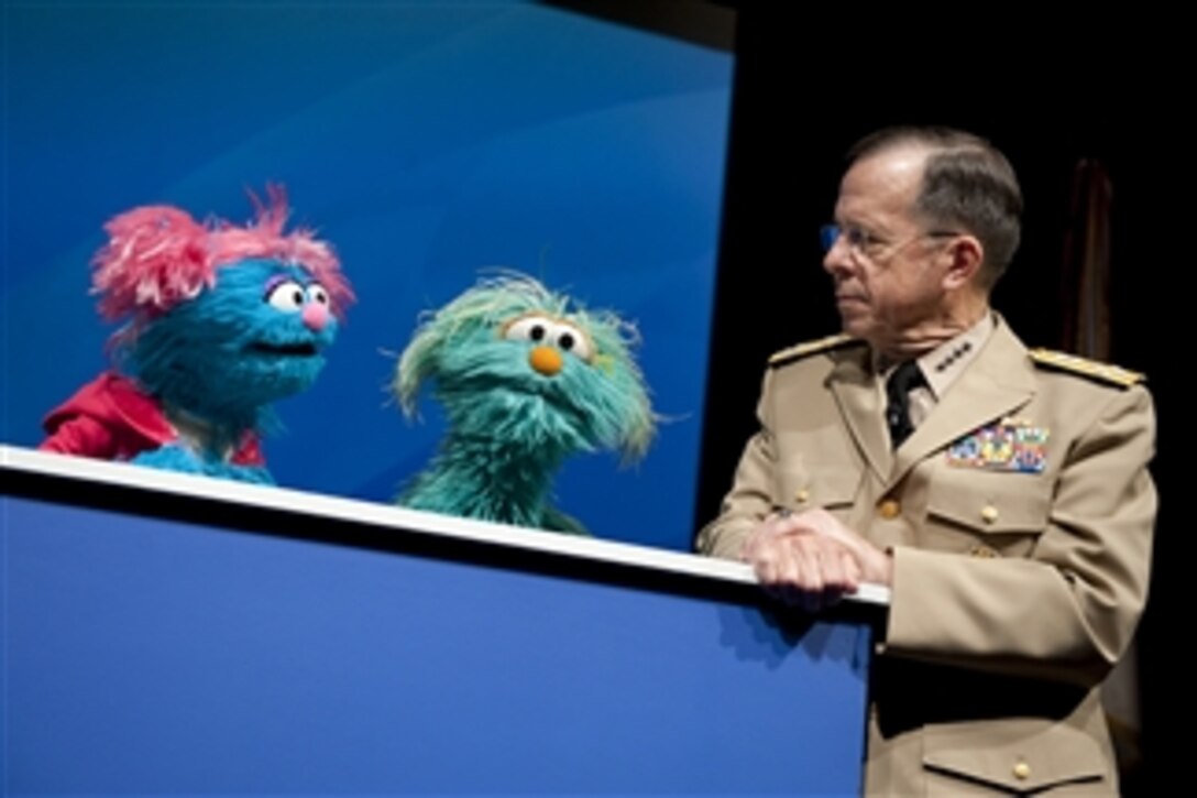 Chairman of the Joint Chiefs of Staff Adm. Mike Mullen speaks with Sesame Street Muppets Jesse and Rosita at a preview of the PBS special "When Families Grieve" in the Pentagon on April 13, 2010.  The program portrays the tales of children coping with the loss of a parent and skills that have helped them move forward.  
