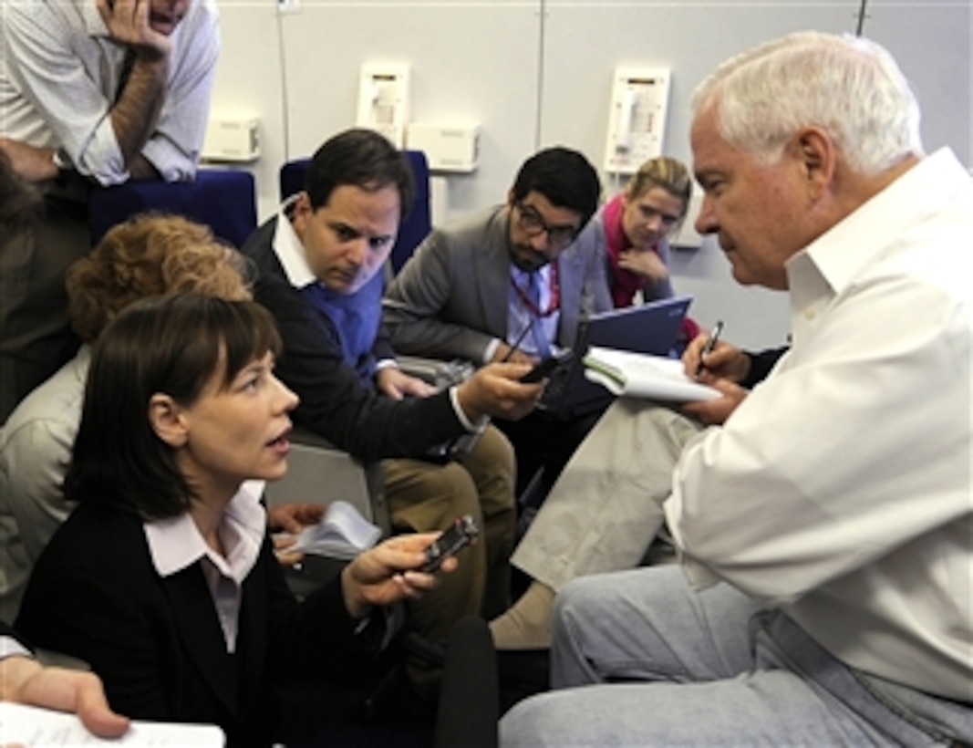 Secretary of Defense Robert M. Gates listens to a question from AP journalist Anne Flaherty while traveling onboard a U.S. Air Force E-4B National Airborne Operations Center aircraft en route to Lima, Peru, as part of a four day trip to South America on April 13, 2010.  