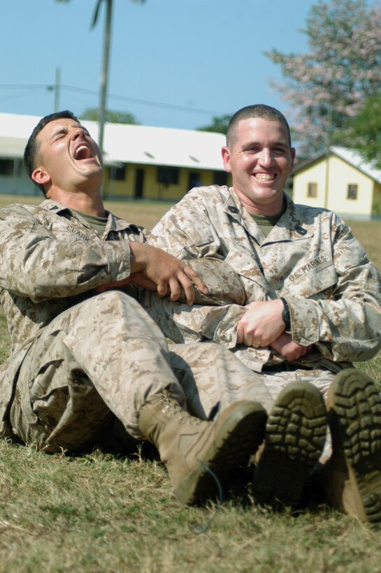 Marine Cpl. Derrick Clark, Lexington, Ky., native and Gunnery Sgt. Christopher Lake, both military policeman with Military Police Co. A, share an electroshock of 1,200 volts from an X26E taser gun. They demonstrated the experience for the students of the week-long non-lethal weapons course during Tradewinds 2010, a Chairman of the Joint Chiefs directed, U.S. Southern Command sponsored annual exercise that is conducted with Caribbean Basin Partner Nations, designed to improve cooperation in responding to regional security threats.