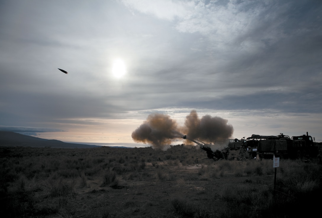 A 155 mm high explosive artillery round accelerates to faster than the speed of sound after being fired from gun four’s Howitzer long range artillery weapon. At that moment, Bravo Battery was on a battery wide fire mission where all four guns fire simultaneously to suppress a target.
