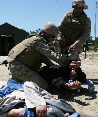 Corpsmen from 2nd Medical Battalion, Combat Logistics Regiment 25, 2nd Marine Logistics Group, respond to Afghan role players pretending to be injured by improvised explosive devices during a field exercise aboard Camp Lejeune, N.C., April 12-18, 2010.  The exercise focused on improvised explosive device training, basic urban skills training and Afghan cultural training using Afghan role players as well as medical training for Marines and sailors in order to prepare the battalion for upcoming deployments to Afghanistan. (U.S. Marine Corps photo by Cpl. Meghan J. Canlas)