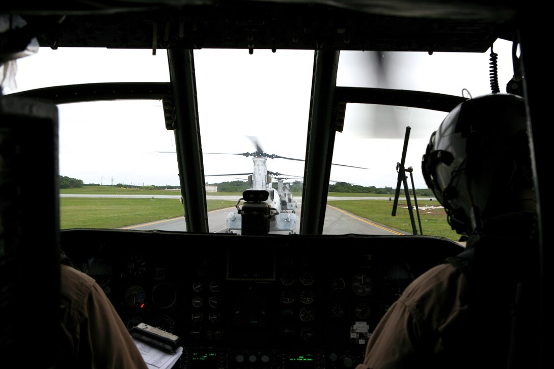 Pilots of a CH-46E Sea Knight from Marine Medium Helicopter Squadron 262, Marine Aircraft Group 36, 1st Marine Aircraft Wing, III Marine Expeditionary Force, wait for the go ahead to launch from Marine Corps Air Station Futenma April 15.