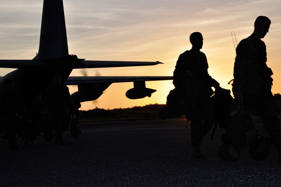 ANDERSEN AIR FORCE BASE, Guam-Maritime Raid Force, 31st Marine Expeditionary Unit, III Maring Expeditionary Force, Marines unload from a C-130 that landed on Andersen Air Force Base Northwest, Guam, April 8 to complete Situational Training Exercise 3, Realistic Urban Training Exercise 10-1. (U.S. Marine Corps photo by Cpl. Rebekka Heite)