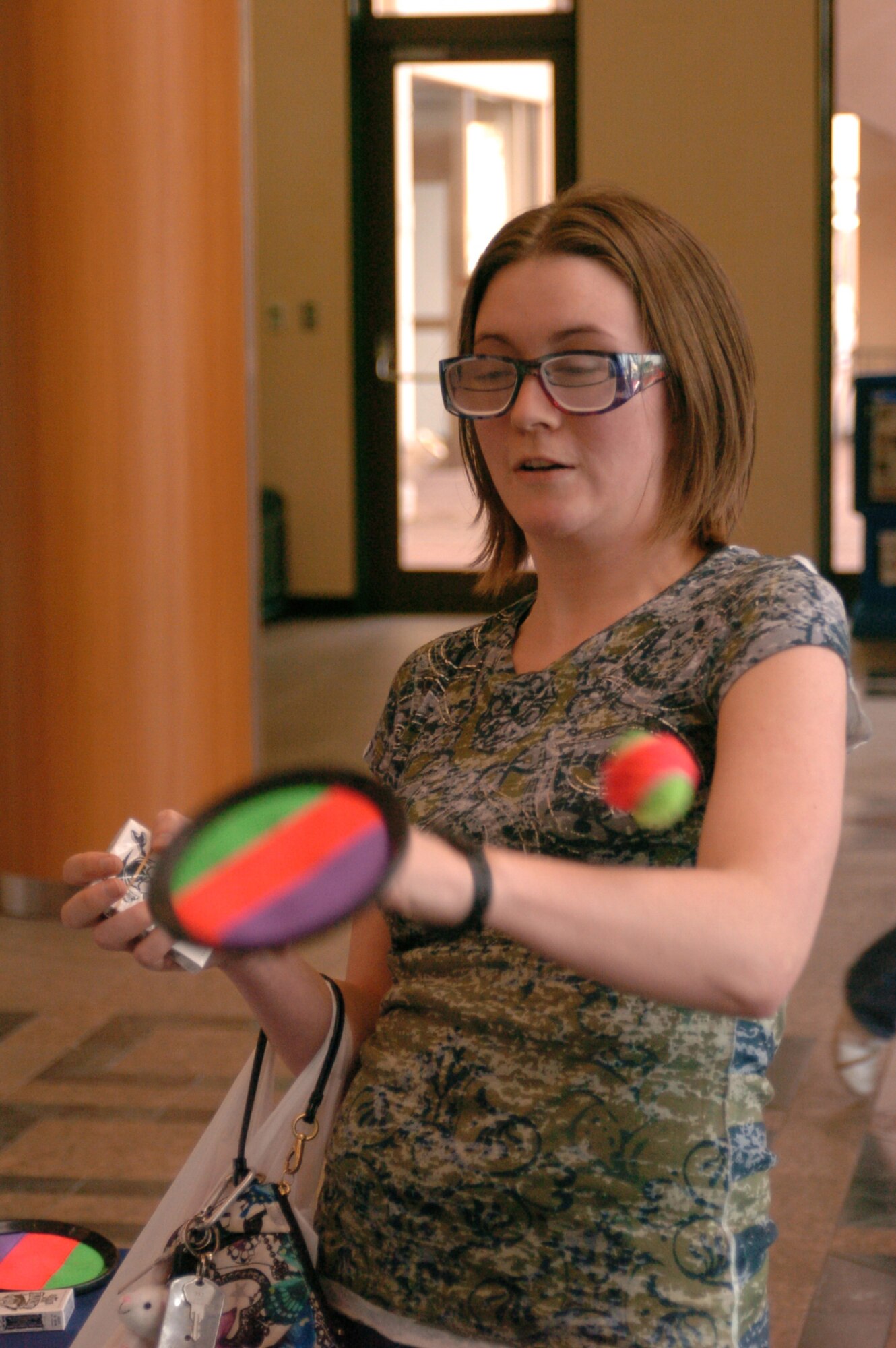 YOKOTA AIR BASE, Japan -- Senior Airman Hollie Crawford, 374th Medical Group laboratory technician, tries to catch a ball while impaired by a pair of 'beer goggles,' April 13. As part of Alcohol Abuse Awareness Month, Yokota's Alcohol and Drug Abuse Prevention and Treatment (ADAPT) program demonstrated the effects of alcohol on awareness. (U.S. Air Force photo/Airman 1st Class Katrina R. Menchaca)