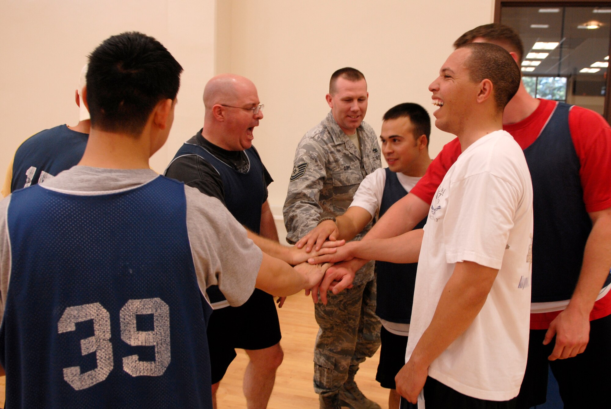 VANDENBERG AIR FORCE BASE, Calif. -- The 30th Logistics Readiness Squadron team yells out the team's chant after winning the match during an intramural volleyball game at the base fitness center here Tuesday, April 13, 2010.  The 30th LRS team won both matches, 25-10 and 25-12.  (U.S. Air Force photo/Senior Airman Andrew Satran) 

 
 

 

 

 
 

 

 

 

 