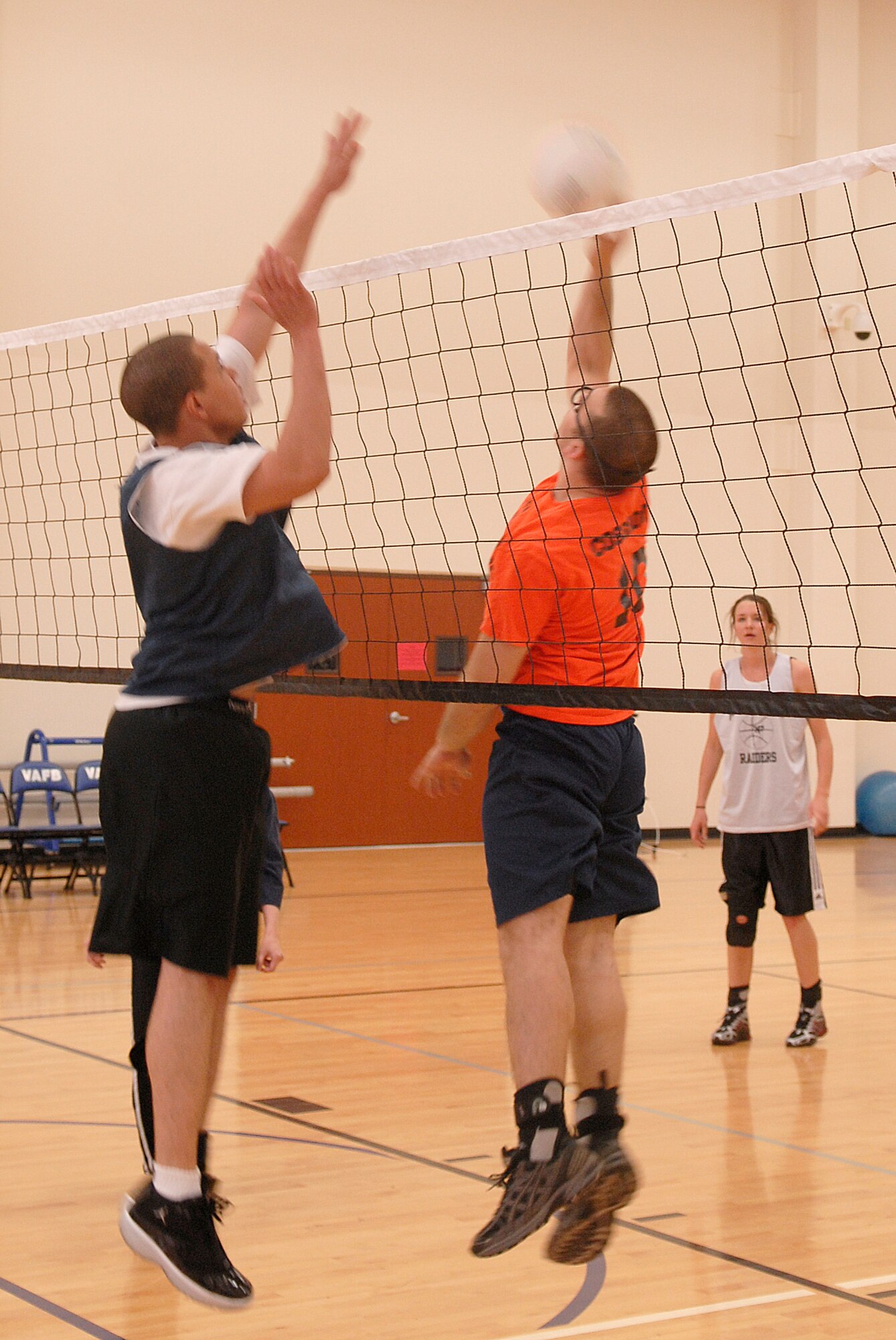 VANDENBERG AIR FORCE BASE, Calif. -- Defending for the 30th Logistics Readiness Squadron team, Marques Martin  prepares to block a spike from William Cosgrove, a 14th Air Force Team 2 team member, during an intramural volleyball game at the base fitness center here Tuesday, April 13, 2010.  The teams are now halfway into their seasons. (U.S. Air Force photo/Senior Airman Andrew Satran) 

 

 