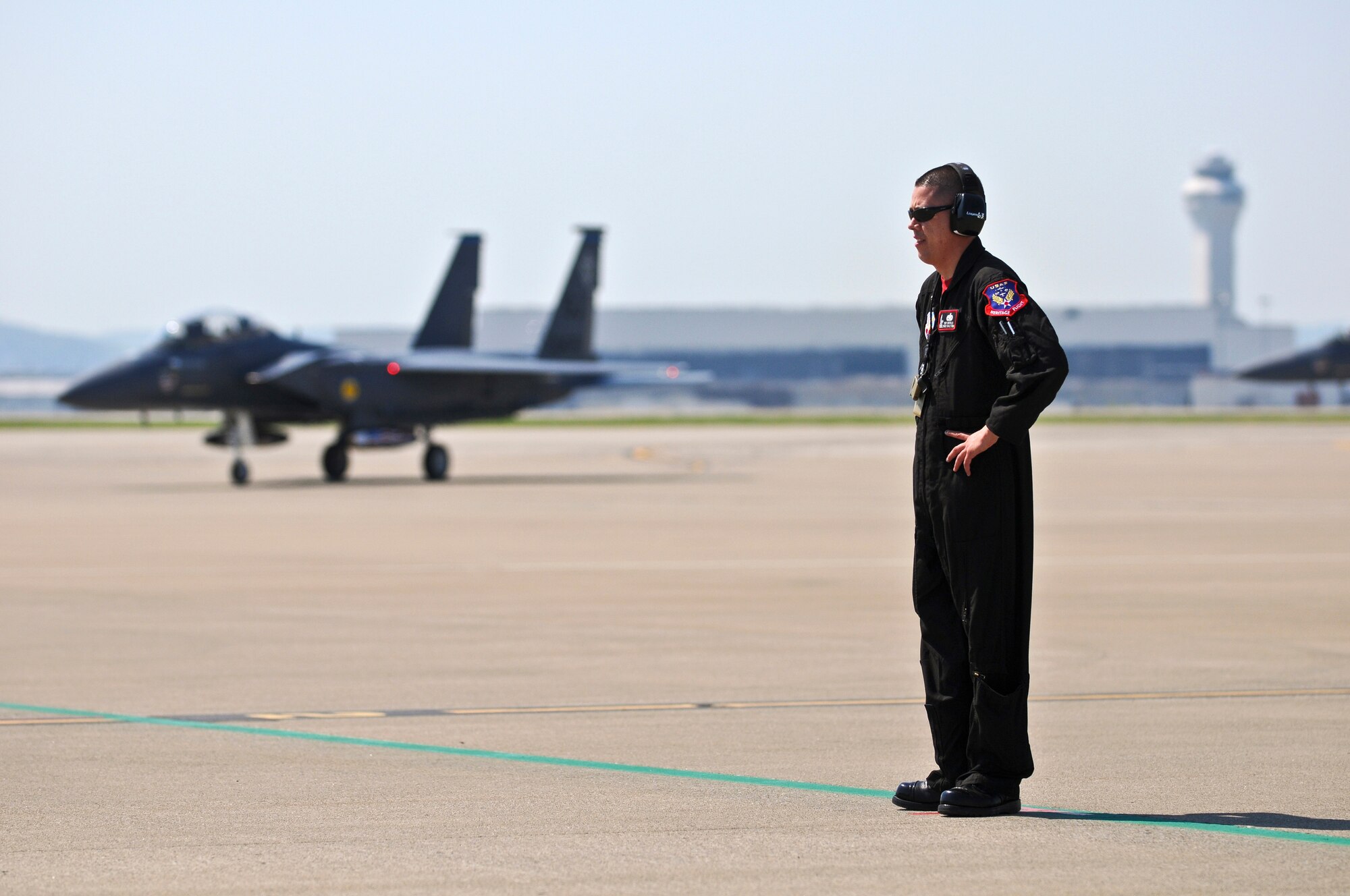 Staff Sgt. Gabriel Castillo, a U.S. Air Force crew chief with the 4th Fighter Wing at Seymor Johnson Air Force Base, N.C., stands by to marshall an F-15 Strike Eagle to its parking spot on the Kentucky Air National Guard Base flightline in Louisville, Ky., on April 15, 2010. The F-15 will participate in this weekend's Thunder Over Louisville airshow. (U.S. Air Force photo by Senior Airman Maxwell A. Rechel)