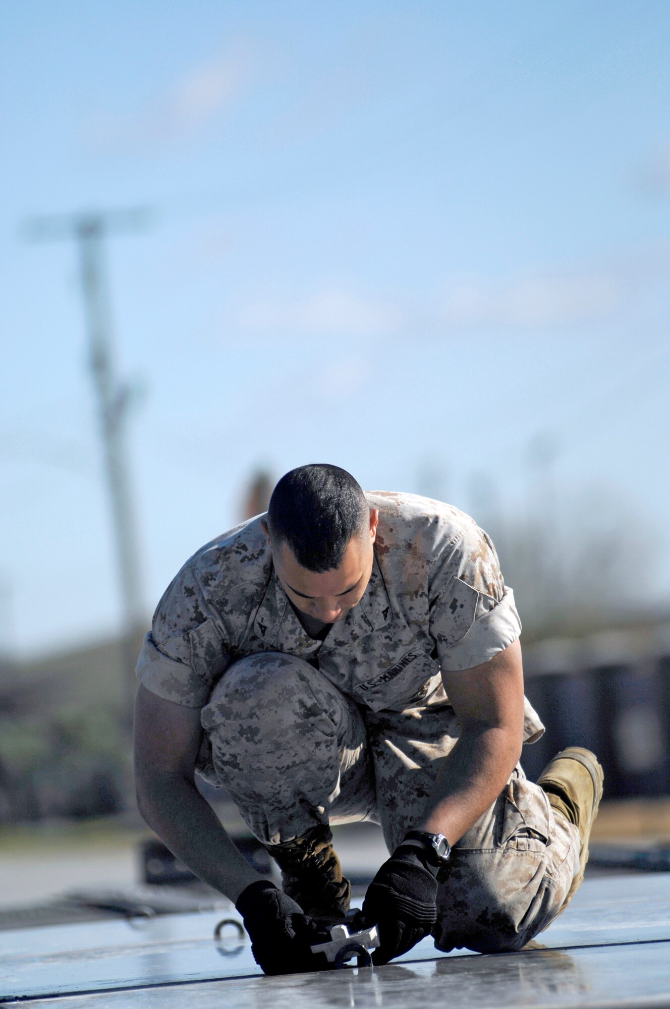 Marine Lance Cpl. Garren Robinson locks two air cargo pallets together in preparation for the loading of a mine-resistant, ambush-protected all-terrain vehicle March 23, 2010, at Joint Base Charleston, S.C. Corporal Garren is with the 4th Marine Logistics Group, 4th Atlanta Support Battalion, Charlie Company. (U.S. Air Force photo/Senior Airman Timothy Taylor)