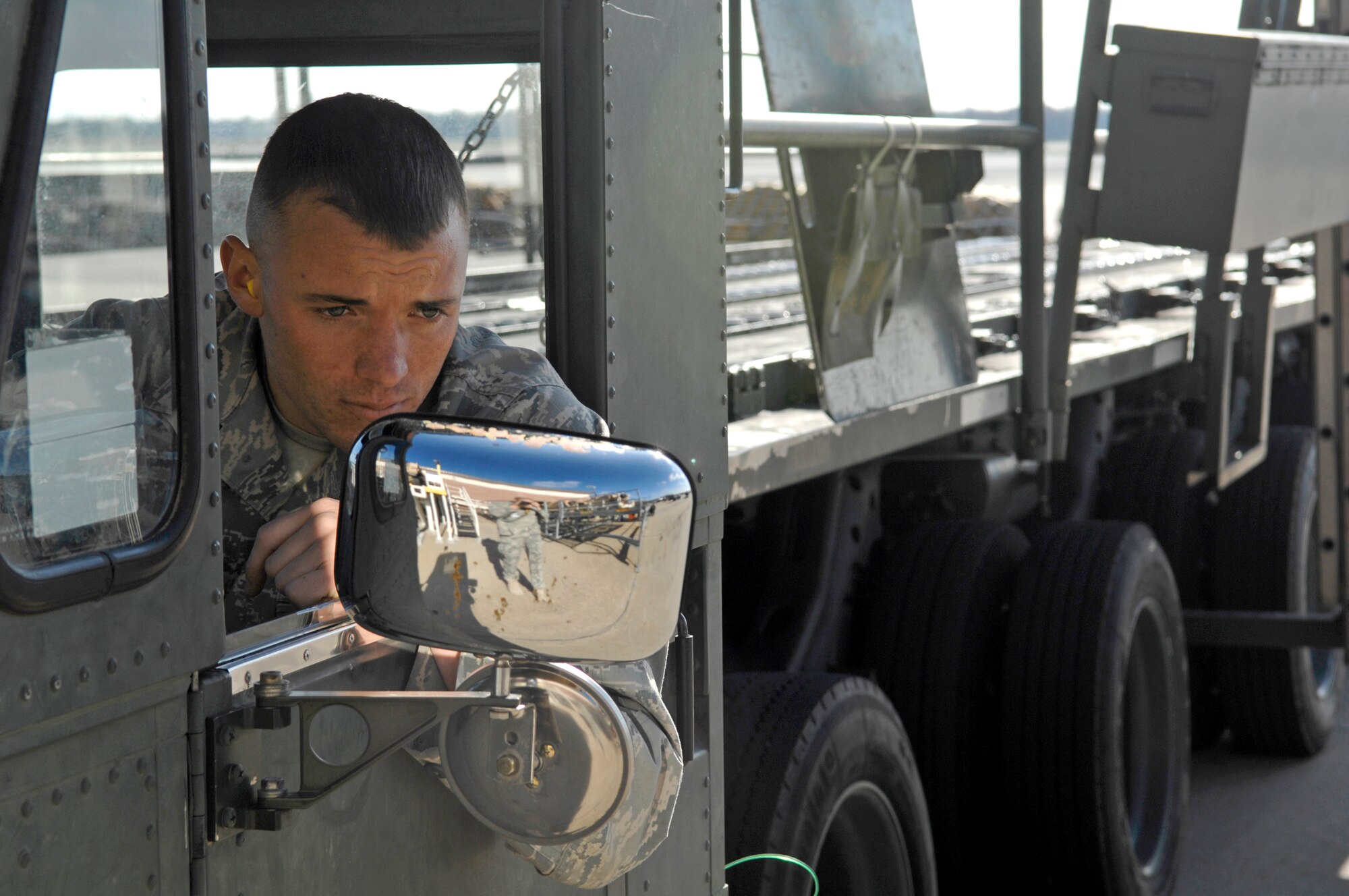 Airman 1st Class Michael Speaks backs up a Tunner 60K loader after off-loading two mine-resistant, ambush-protected all-terrain vehicles March 23, 2010, at Joint Base Charleston, S.C. Airman Speaks is an air transportation technician with the 437th Aerial Port Squadron. (U.S. Air Force photo/Senior Airman Timothy Taylor)
