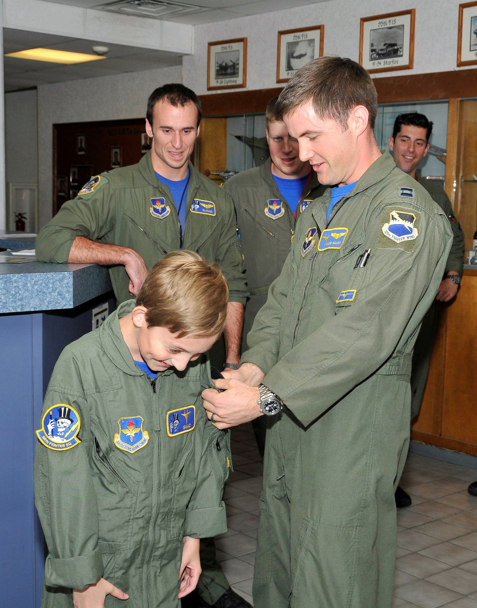 Capt. Caleb Haley presents Isaac Ezell with a 95th Fighter Squadron patch signifying the completion of his Pilot for a Day activities April 9, 2010, at Tyndall Air Force Base, Fla. Captain Haley is the 95th Fighter Squadron flight commander. (U.S. Air Force photo/Lisa Norman)