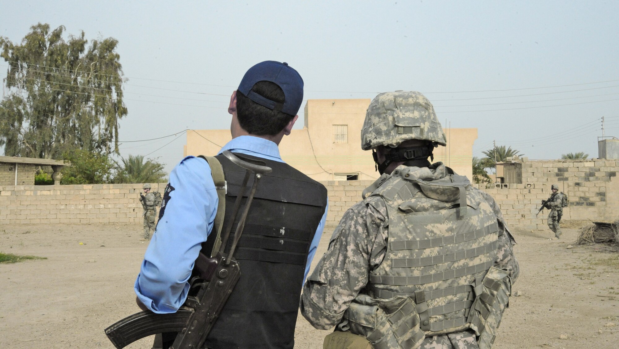 A security forces member and an Iraqi police officer discuss recent attacks during a joint presence patrol April 4, 2010, near Rufush, Iraq. (U.S. Air Force photo/Master Sgt. Trish Bunting)
