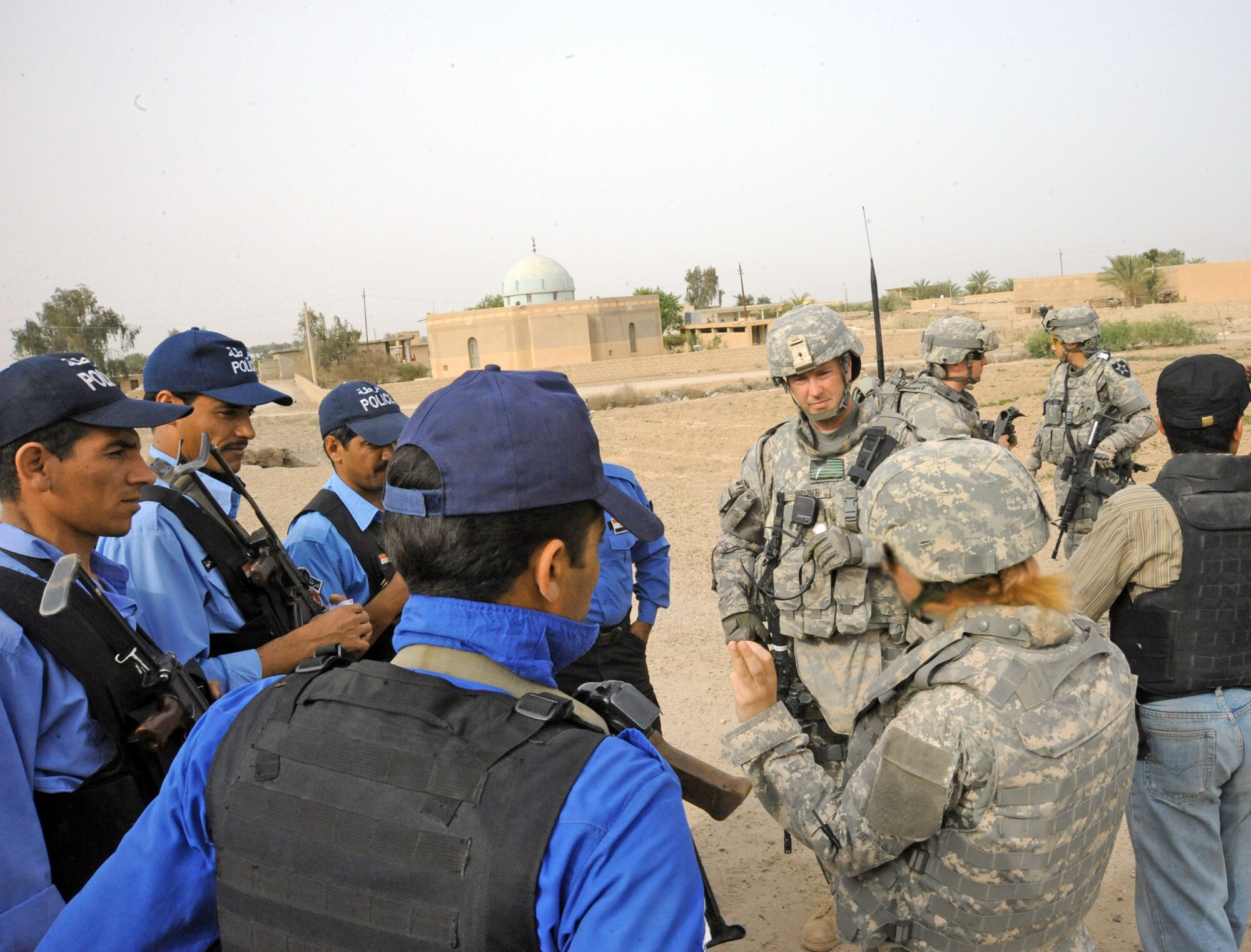 Members of the 732nd Expeditionary Security Forces Squadron Det. 2 discuss the joint presence patrol April 4, 2010, near Rufush, Iraq. (U.S. Air Force photo/Master Sgt. Trish Bunting)