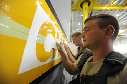 U.S. Air Force Staff Sgt. Michael Reed applies a squeegee to a Charleston stencil to ensure good connectivity April 15, 2010, at Joint Base Charleston, S.C. After the stencil is applied, the letters are painted over to highlight the word "Charleston." Sergeant Reed is an aircraft structural maintenance craftsman with the 437th Maintenance Squadron. (U.S. Air Force photo by James M. Bowman/released)