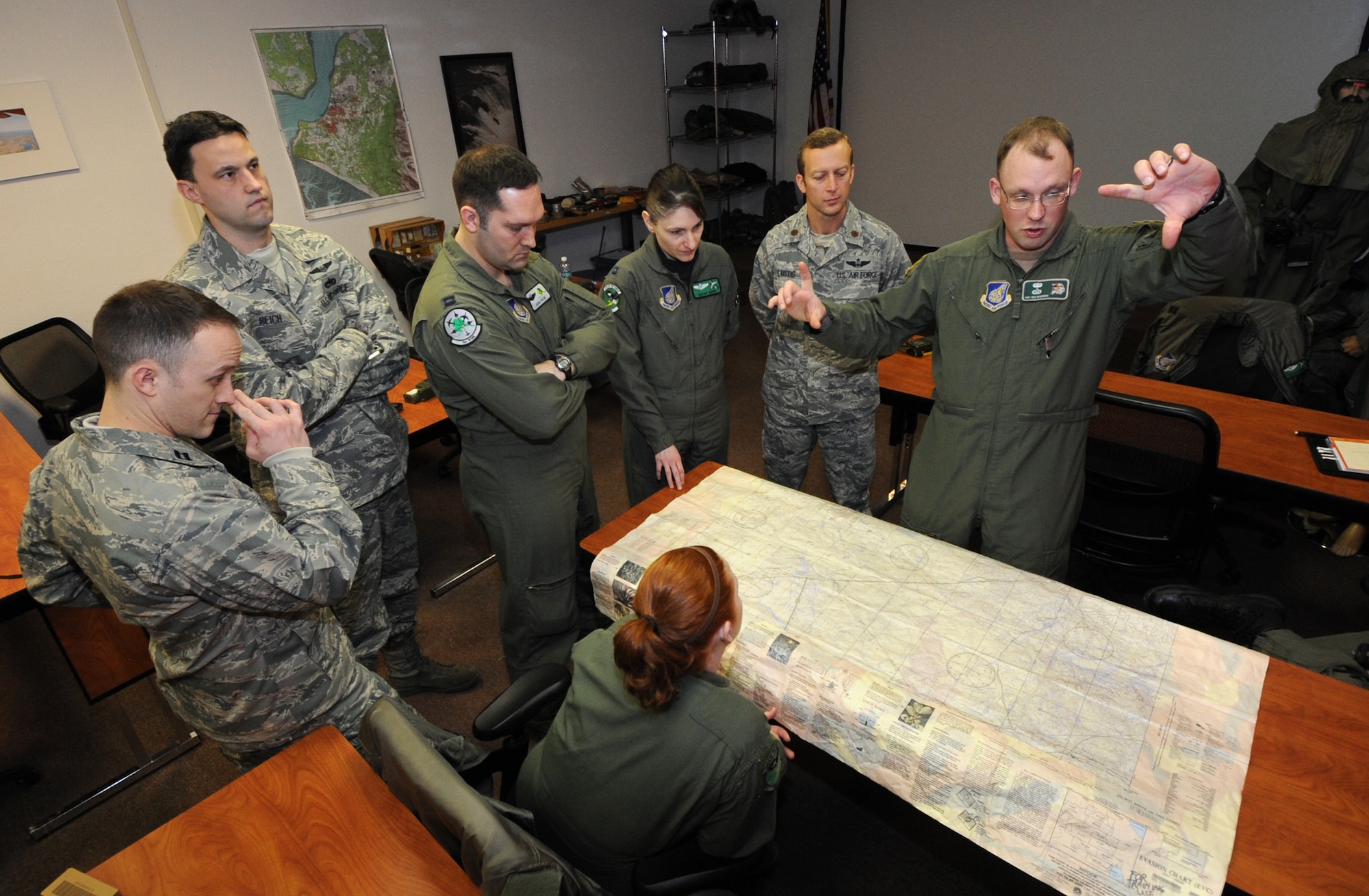 ELMENDORF AIR FORCE BASE, Alaska -- Staff Sgt. Reid Beveridge instructs a class about how to pinpoint coordinates on a map during Survival, Evasion, Resistance and Escape training April 12. The classroom SERE training covered hands on learning with maps, GPS units and radios. Sergeant Beveridge is a SERE specialist with the 3rd Operation Support Squadron Weapons and Tactics Flight. (Air Force photo by Senior Airman Cynthia Spalding)