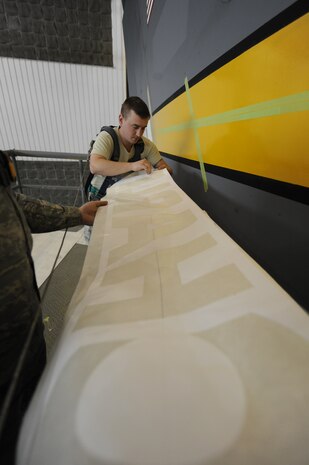 U.S. Air Force Staff Sgt. Michael Reed removes a Charleston stencil from its backing April 15, 2010, at Joint Base Charleston, S.C. Removing the stencil allows Airmen to apply the Charleston letters the tail of the aircraft to be painted. Sergeant Reed is an aircraft structural maintenance craftsman with the 437th Maintenance Squadron. (U.S. Air Force photo/James Bowman/released)