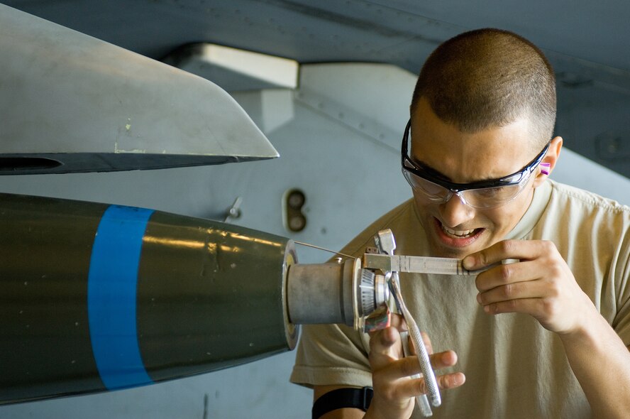 Airman 1st Class Taylor Quintero, 56th Aircraft Maintenance Squadron weapons technician, insures that an inert bomb is ready for deployment while competing in a load crew competition at Luke Air Force Base, Ariz., April 9. The load crew competition gives the crews an opportunity to display their skills to the wing. (U.S. Air Force Photo by Staff Sgt. Jason Colbert)