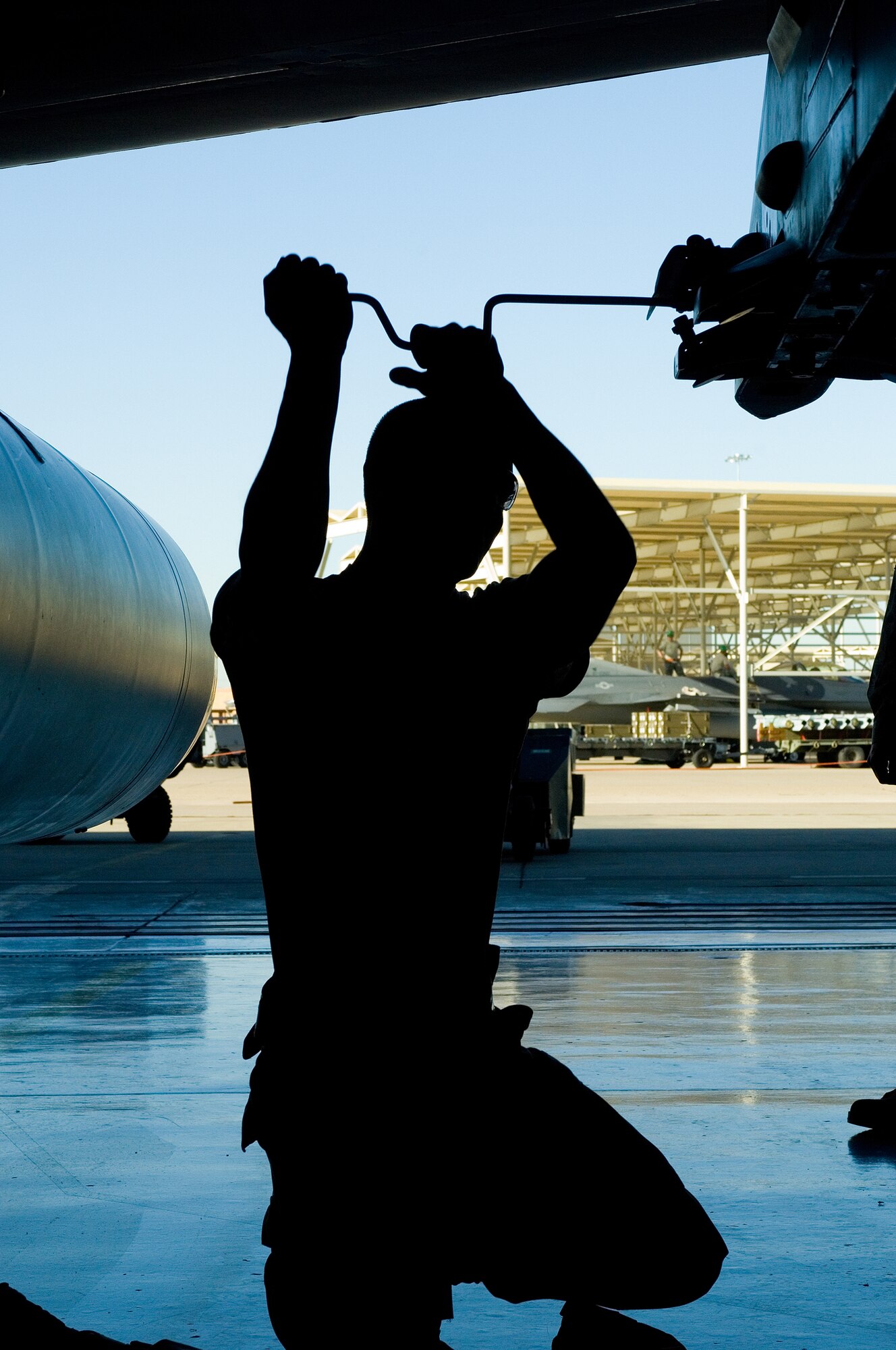 Airman 1st Class Taylor Quintero, 56th Aircraft Maintenance Squadron weapons technicians, installs an impulse cart during the Load Crew Competition at Luke Air Force Base, Ariz., April 9. The winner of the competition wins at the Wing level for the quarter. (U.S. Air Force Photo by Staff Sgt. Jason Colbert)