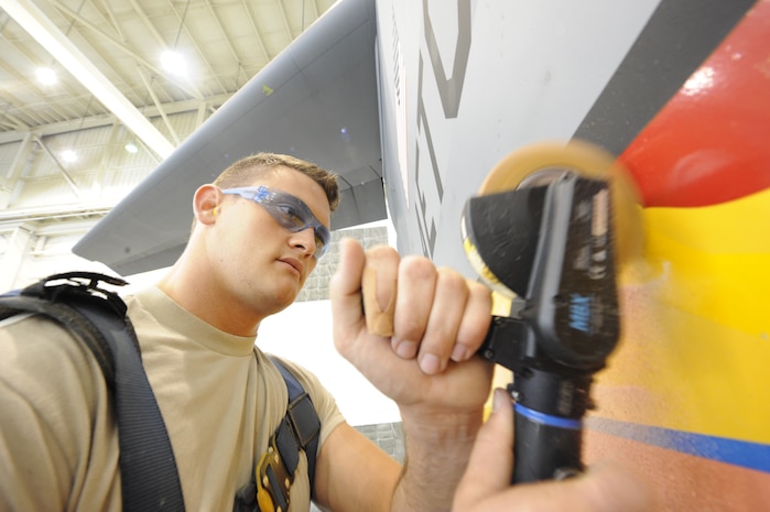 U.S. Air Force Airman 1st Class Jacob Carey removes an Altus C-17 tail flash with an air operated decal remover April 12, 2010, at Joint Base Charleston, S.C. Removing the the old tail flash vinyl is the first step on transforming the aircraft into a Charleston C-17. Airman Carey is an aircraft structural maintenance journeyman with the 437th Maintenance Squadron. (U.S. Air Force photo by James M. Bowman/released)