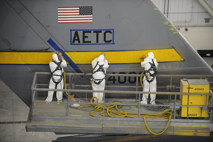 U.S. Air Force Airmen from the 437th Maintenance Squadron sand down the tail of a C-17 April 13, 2010, at Joint Base Charleston, S.C. The tail must be sanded down prior to a new Charleston tail flash being added. (U.S. Air Force photo/James M. Bowman/Released)