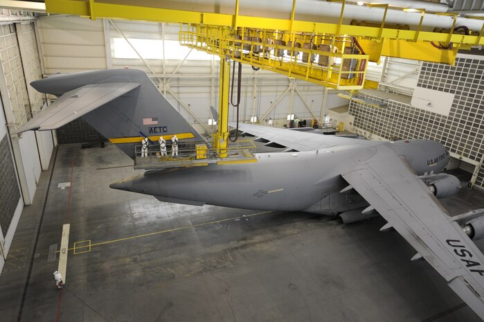 U.S. Air Force Airmen from the 437th Maintenance Squadron sand down the tail of a C-17 April 13, 2010, at Joint Base Charleston, S.C. The tail must be sanded down prior to a new Charleston tail flash being added. (U.S. Air Force photo/James M. Bowman/Released)