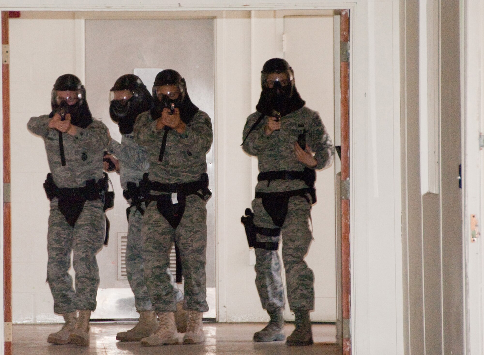 HANSCOM AIR FORCE BASE, Mass. -- 66th Security Forces Squadron members move
in formation to secure the hallway of a building during an April 12 training with the Massachusetts State Police Special Tactical Operations team. The STOP team instructed Hanscom security forces members in specialized methods for neutralizing active-shooter situations.  (U.S. Air Force photo by Rick Berry)
