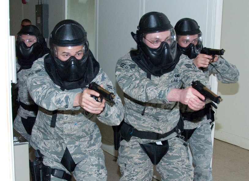 HANSCOM AIR FORCE BASE, Mass. -- During an active-shooter simulation, which was part of a specialized training with the Massachusetts State Police Special Tactical Operations team, 66th Security Forces Squadron members Tech. Sgt. Charles Humphrey (left), Airman 1st Class Tylor Stolp, Senior Airman Michael Walters and A1C Kyle Madden move in formation along building corridors. The training, held April 12, instructed Hanscom security forces Airmen in diffusing active-shooter scenarios.  (U.S. Air Force photo by Rick Berry) 