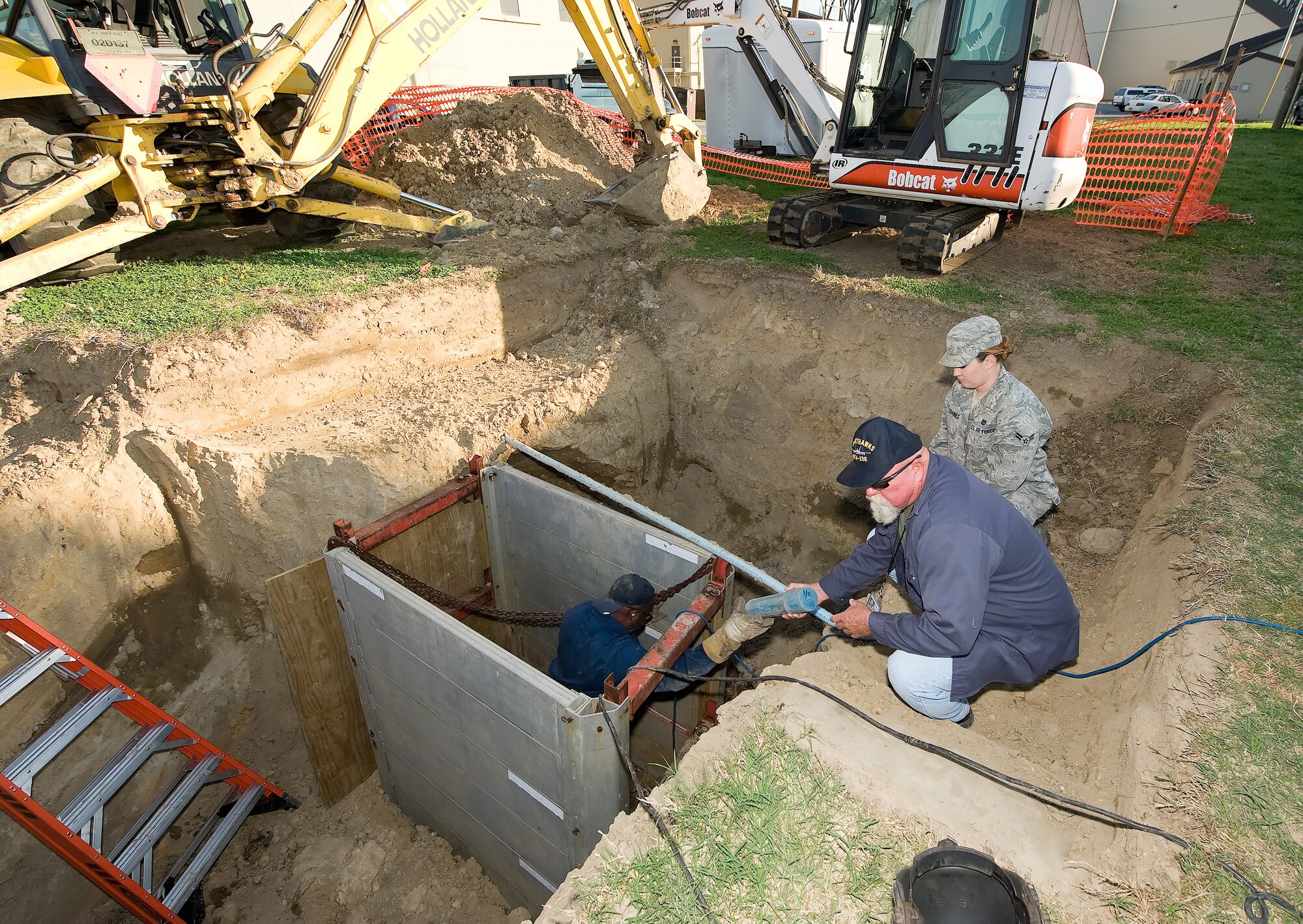 (Left to right) Thomas Bell, 436th Civil Engineer Squadron; Glenn Meadows, 436th CES; and Airman 1st Class Kristal Deschaines, 436th CES, work to fix a broken section of heat plant line April 7. The heat plant sprung a leak losing about 13,000 gallons of water a day for two weeks. This leak was spotted by a Delaware State Police helicopter using thermal imaging. (U.S. Air Force photo/Jason Minto)
