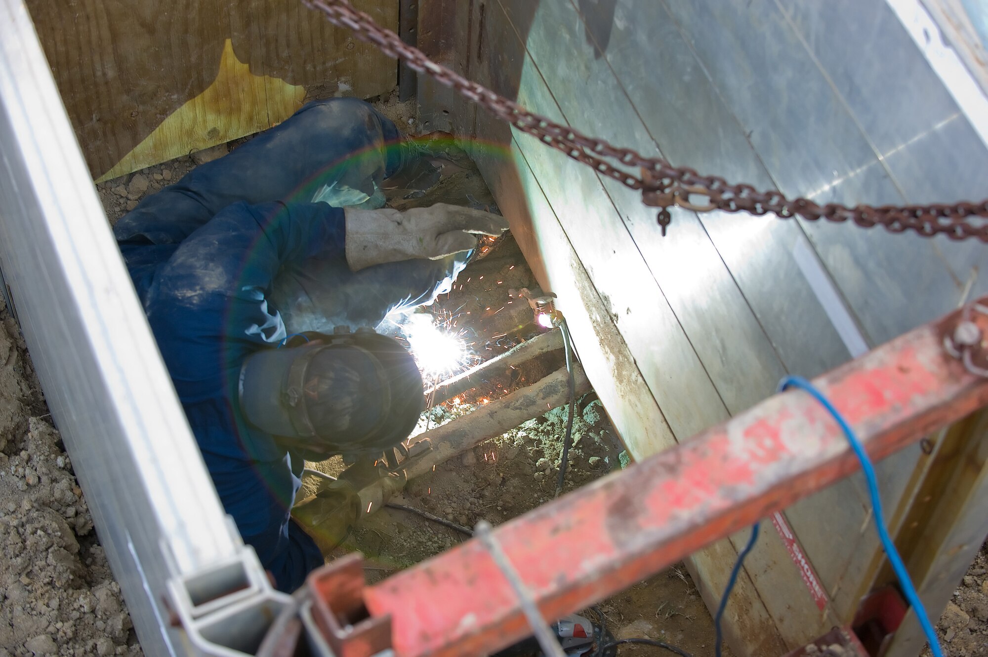 Thomas Bell, 436th Civil Engineer Squadron, welds the broken section of a heat plant line April 7. The leak was discovered after a Delaware State Police helicopter assisted 436th CES with thermal imaging. (U.S. Air Force photo/Jason Minto)