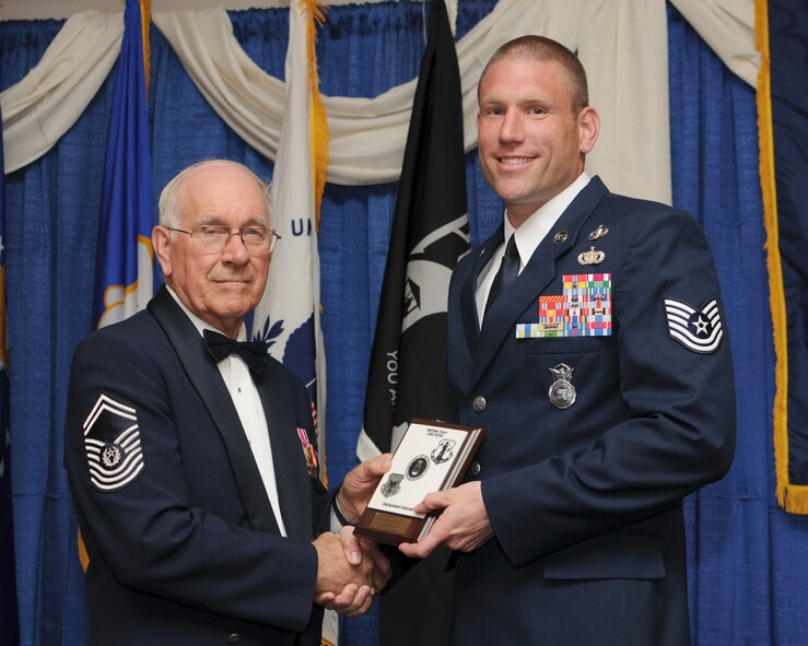 McGHEE TYSON AIR NATIONAL GUARD BASE, Tenn. -- Tech. Sgt. Justin L. Geers, Fort Leonard Wood, Mo., receives the distinguished graduate award for NCO Academy Class 10-4 at The I.G. Brown Air National Guard Training and Education Center here from retired Chief Master Sergeant of the Air Force Sam E. Parish, April 7, 2010. The distinguished graduate award is presented to students in the top ten percent of the class.  It is based on objective and performance evaluations, demonstrated leadership, and performance as a team player. (U.S. Air Force photo by Master Sgt. Kurt Skoglund/Released)