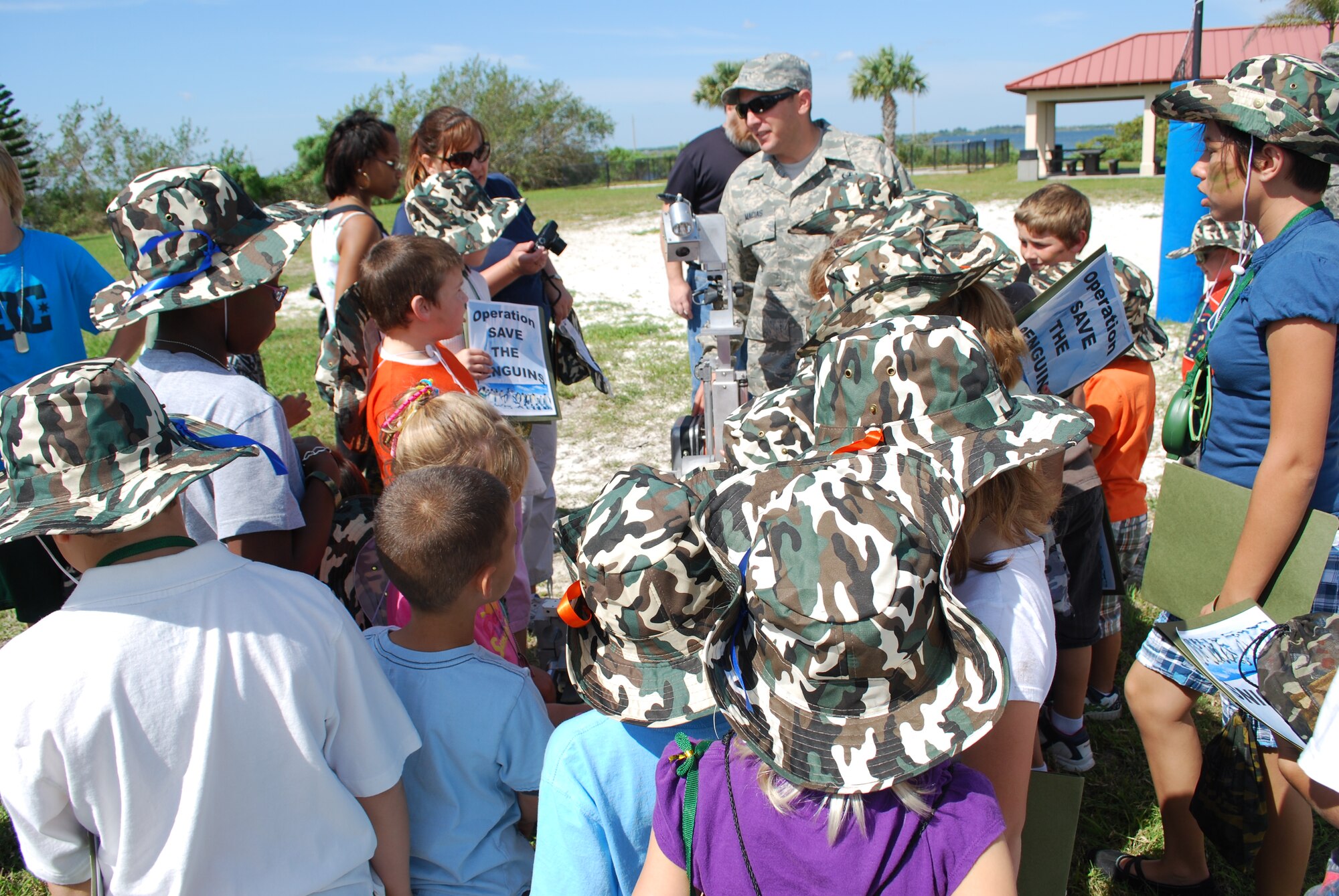 Children got up close and personal with an Explosive Ordnance Disposal robot under the watchful eye of Staff Sgt. Justin Macias at the Kids Understanding Deployment Operations event April 10. The KUDOS program is part of the Year of the Air Force Family and helps children learn about deployments. (U.S. Air Force photo/Senior Airman David Dobrydney)