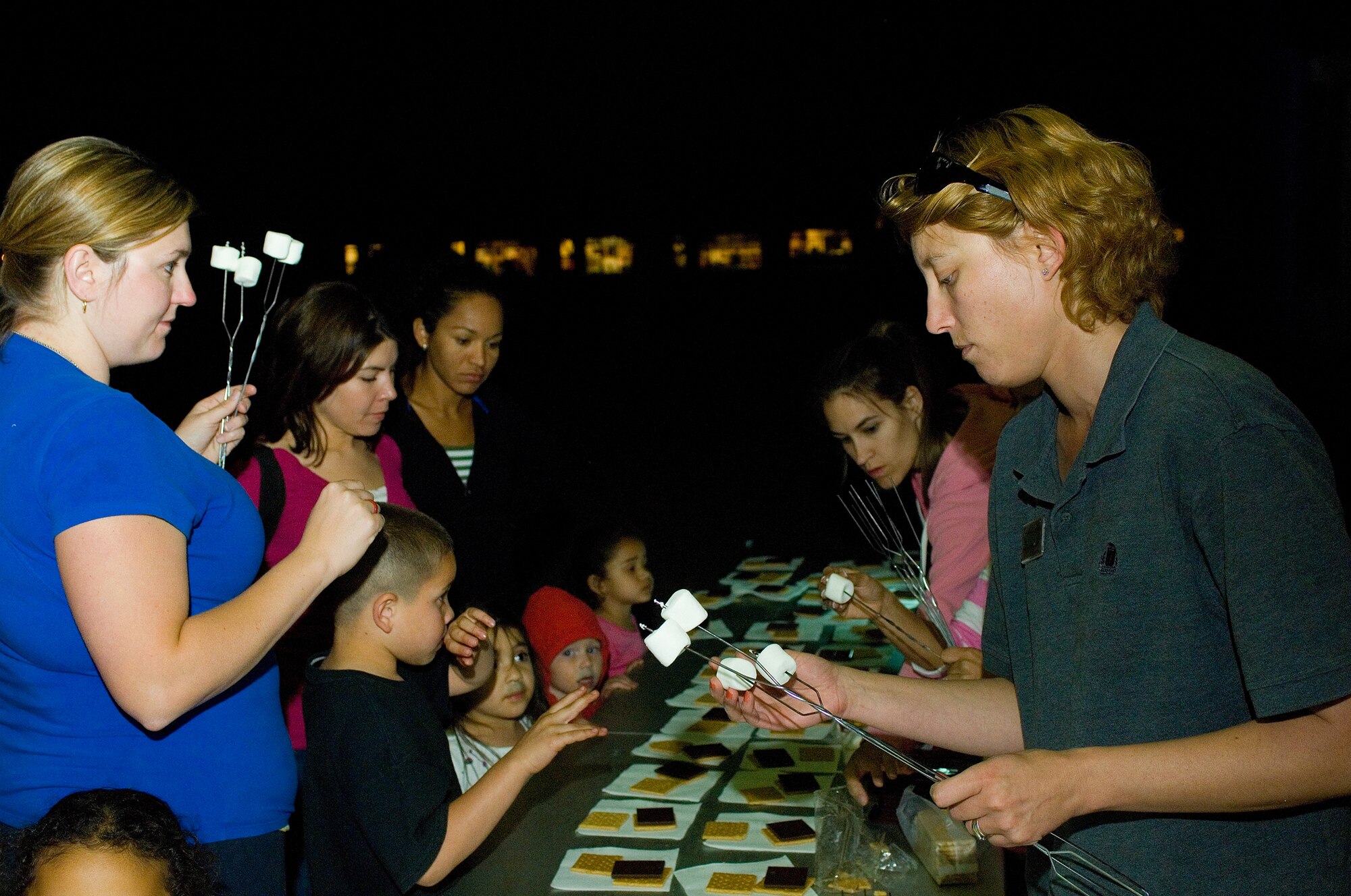 Children line up during the Family Camp Out to receive marshmallows for s'mores at Luke Air Force Base, Ariz., April 9. One hundred and ten people, active duty, retired and dependents, showed up for the event. (U.S. Air Force Photo by Staff Sgt. Jason Colbert)
