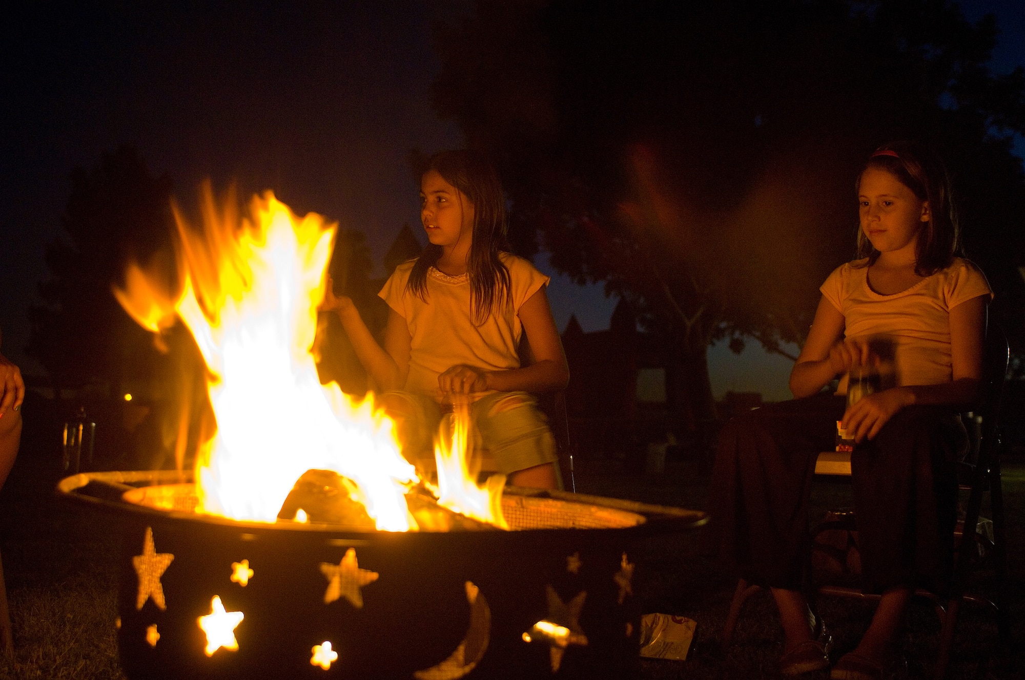 Kayli Hicks, 10, and Alyssa Hicks, 9, tell scary stories around the camp fire during the Family Camp Out at Luke Air Force Base, Ariz.,April 9. One hundred and fifty people, active duty, retired and dependents, signed up for the event. (U.S. Air Force Photo by Staff Sgt. Jason Colbert)