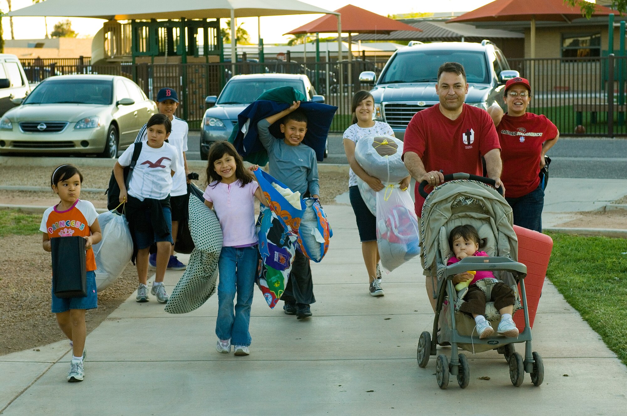 The Reyes, Martinez and Ramirez families arrive to participate in the Family Camp Out at Luke Air Force Base, Ariz., April 9. Participants who signed up through Outdoor Recreation received a tent and 4 sleeping bags to use as well as dinner. (U.S. Air Force Photo by Staff Sgt. Jason Colbert)