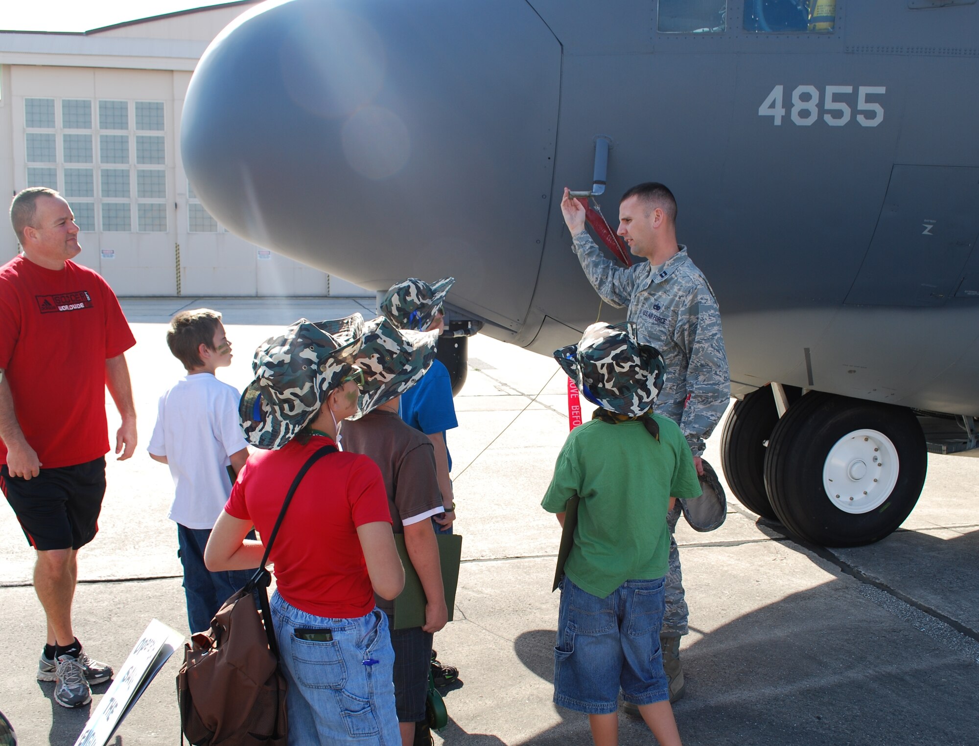 Capt. Dan Posch, a maintenance operations officer with the 920th Rescue Wing, describes a HC-130 aircraft to a group of junior deployers during the Kids Understanding Deployment Operations event April 10. The KUDOS program is part of the Year of the Air Force Family and helps children learn about deployments. (U.S. Air Force photo/Senior Airman David Dobrydney)