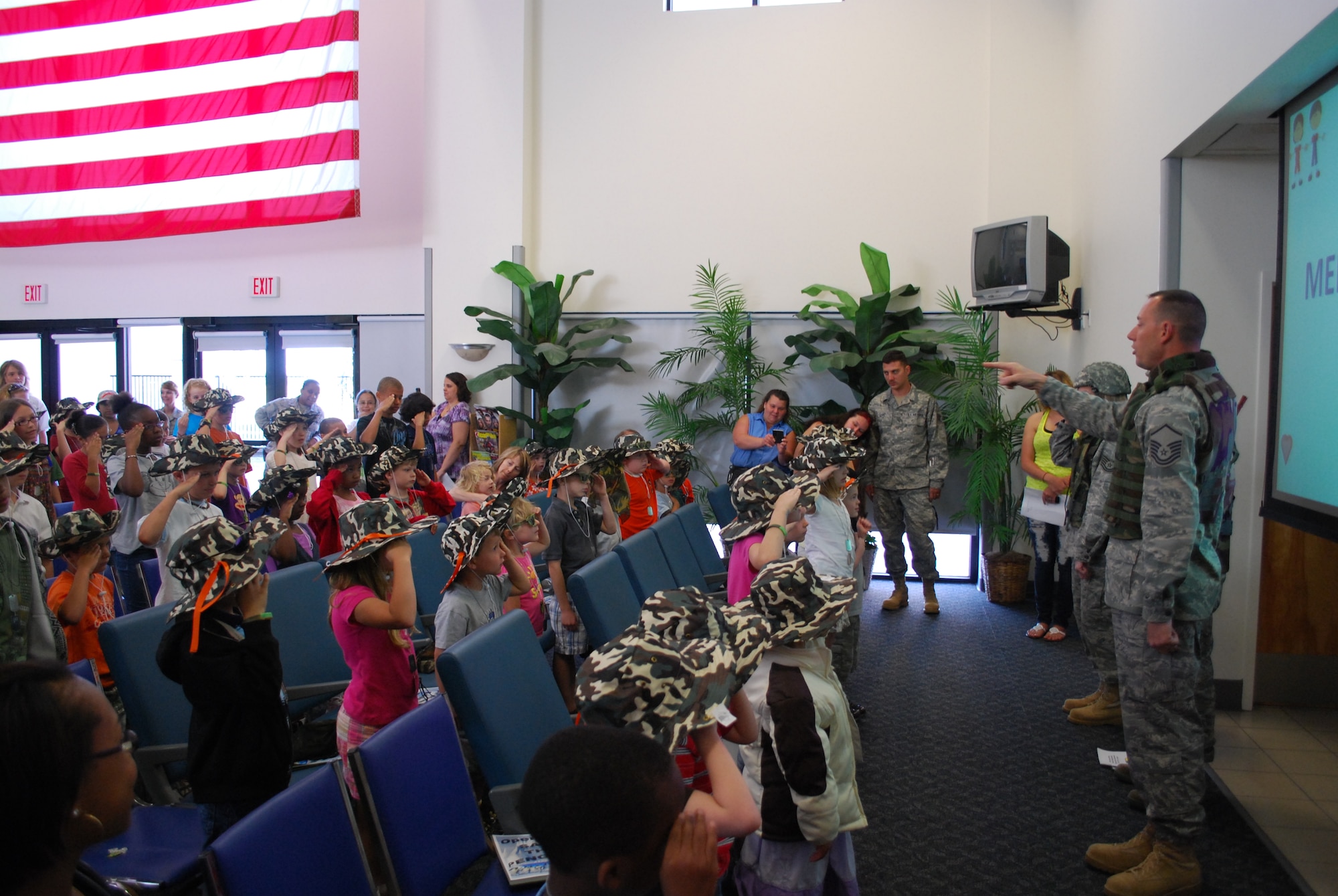 Master Sgt. Adam Brothers of the 45th Civil Engineer Squadron teaches a group of children how to stand at attention and salute during the Kids Understanding Deployment Operations event April 10. The KUDOS program is part of the Year of the Air Force Family and helps children learn about deployments. (U.S. Air Force photo/Senior Airman David Dobrydney)