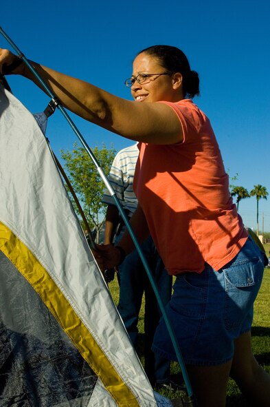 Tech. Sgt. Bronell Grayson, 56th Communication Squadron client support administrator, pitches a tent during the Family Camp Out at Luke Air Force Base, Ariz., April 9. One hundred and fifty people, active duty, retired and dependents, signed up for the event. (U.S. Air Force Photo by Staff Sgt. Jason Colbert)