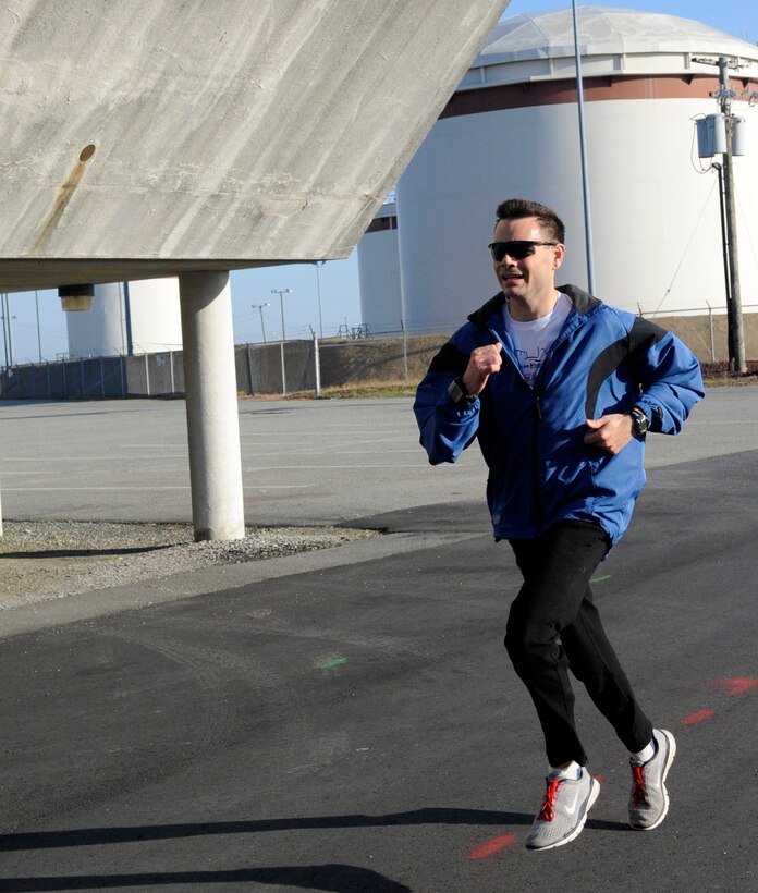 LANGLEY AIR FORCE BASE, Va. - Maj. Shane Vetter, Headquarters Air Combat Command, crosses the finish line first with a time of 36 minutes and 54 seconds during the Tax Day 10k run April 15. Approximately 60 members signed up for the fun run, which aimed to relieve stress and celebrate the completion of tax season. (U.S. Air Force photo/Senior Airman Dana Hill)

