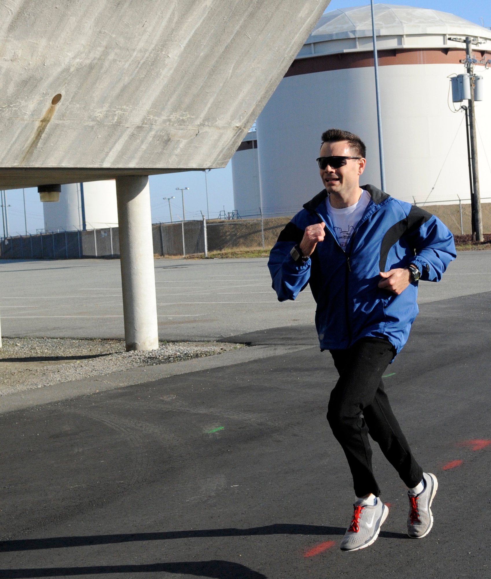 LANGLEY AIR FORCE BASE, Va. - Maj. Shane Vetter, Headquarters Air Combat Command, crosses the finish line first with a time of 36 minutes and 54 seconds during the Tax Day 10k run April 15. Approximately 60 members signed up for the fun run, which aimed to relieve stress and celebrate the completion of tax season. (U.S. Air Force photo/Senior Airman Dana Hill)
