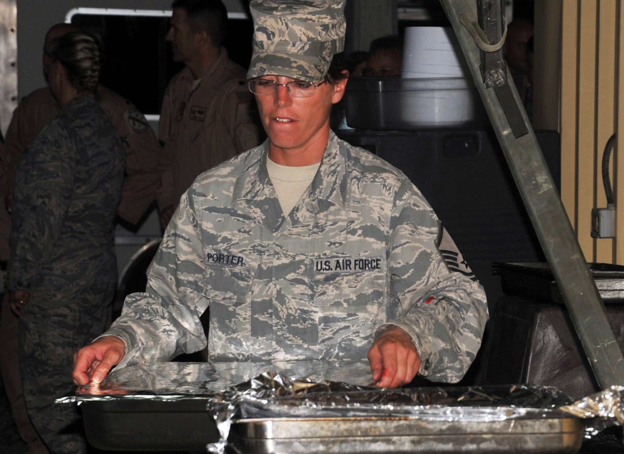 Master Sgt. Dawn Porter, services superintendent with the 380th Expeditionary Force Support Squadron, moves a food tray during a 380th Air Expeditionary Wing event at a non-disclosed base in Southwest Asia on April 12, 2010. Sergeant Porter is deployed from the 127th Force Support Squadron at Selfridge Air National Guard Base, Mich. Her hometown is Detroit, Mich. (U.S. Air Force Photo/Master Sgt. Scott T. Sturkol/Released)