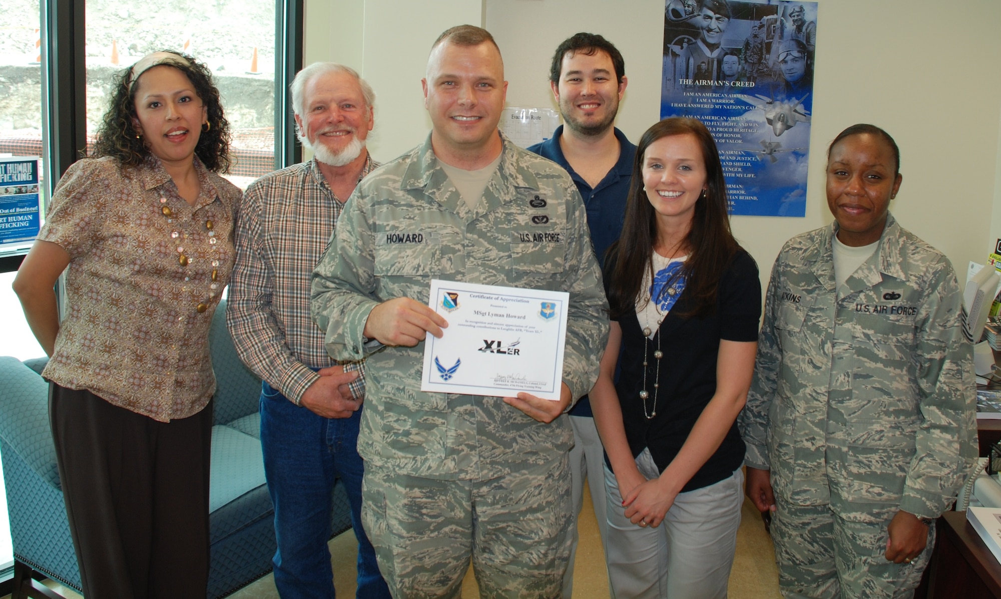 LAUGHLIN AIR FORCE BASE, Texas – Master Sgt. Lyman Howard, 47th Force Support Squadron, poses with fellow members of his unit after being presented the XLer of the Week award by Col. Jeffrey McDaniels, 47th Flying Training Wing commander, April 14. Sergeant Howard is credited with vastly improving Laughlin’s training programs. (U.S. Air Force photo by Airman 1st Class Blake Mize)
