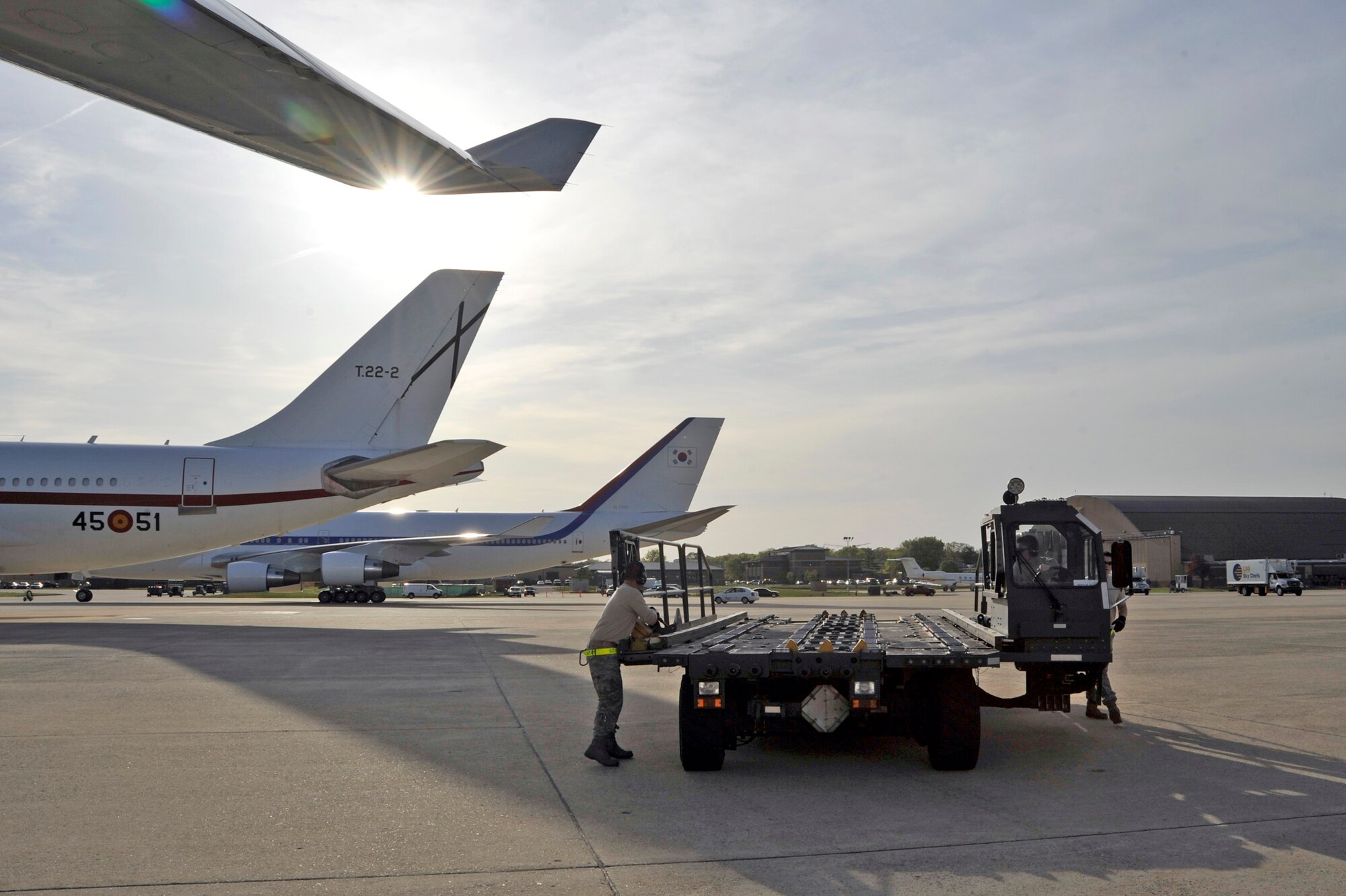 Airmen from 437th Aerial Port Squadron at Charleston Air Force Base, S.C., prepare to offload baggage from the Filipino President Gloria Macapagal-Arroyo's plane after her arrival for the Nuclear Security Summit April 12, 2010, at Joint Base Andrews, Md. (U.S. Air Force photo/Airman 1st Class Perry Aston)
