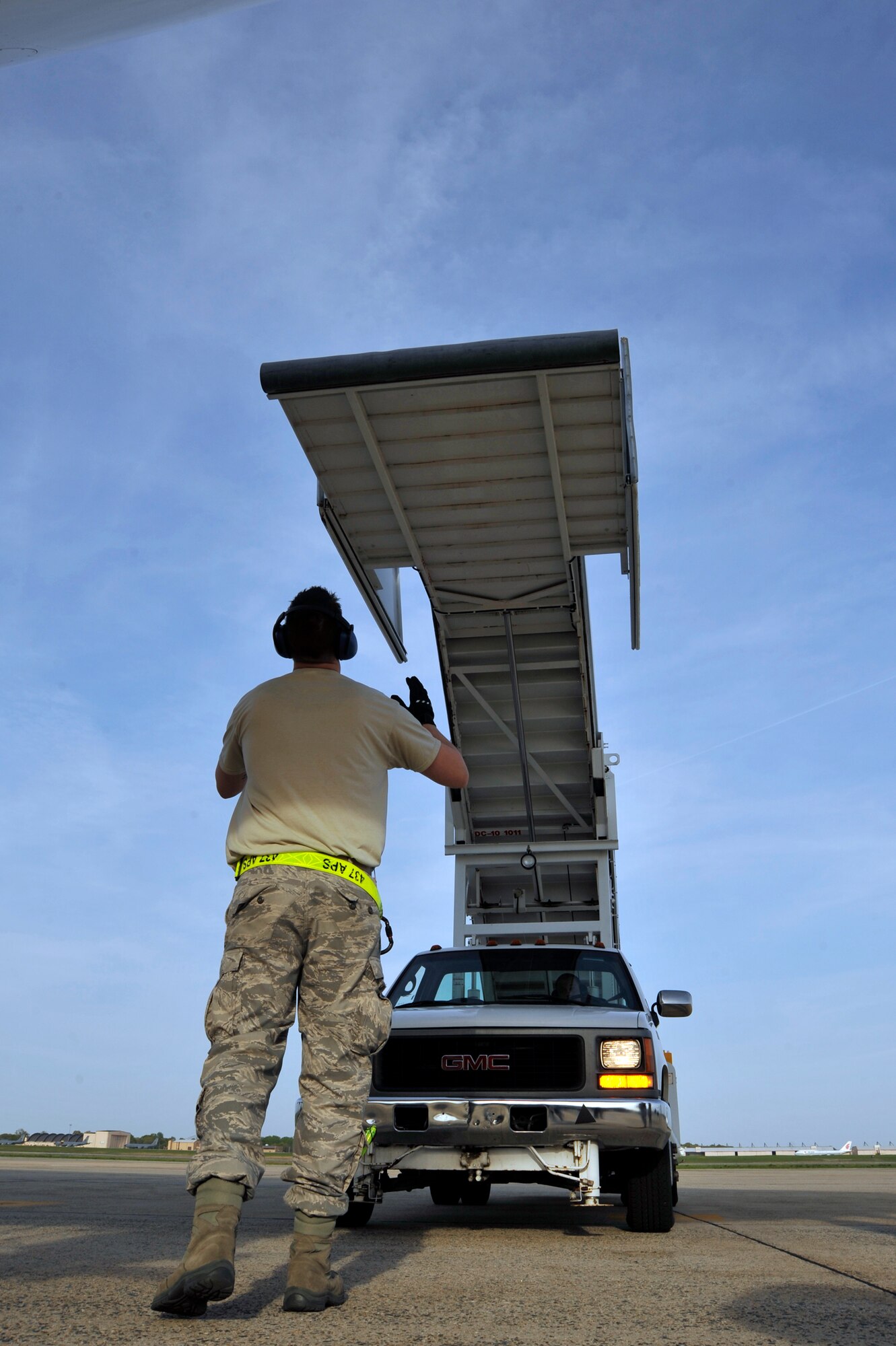 Senior Airman Brian Tater directs the stair truck to door of the Filipino President Gloria Macapagal-Arroyo's plane after her arrival for the Nuclear Security Summit April 12, 2010, at Joint Base Andrews, Md. Airman Tater is an aerial port specialist assigned to the 437th Aerial Port Squadron at Pope Air Force Base, N.C. (U.S. Air Force photo/Airman 1st Class Perry Aston)